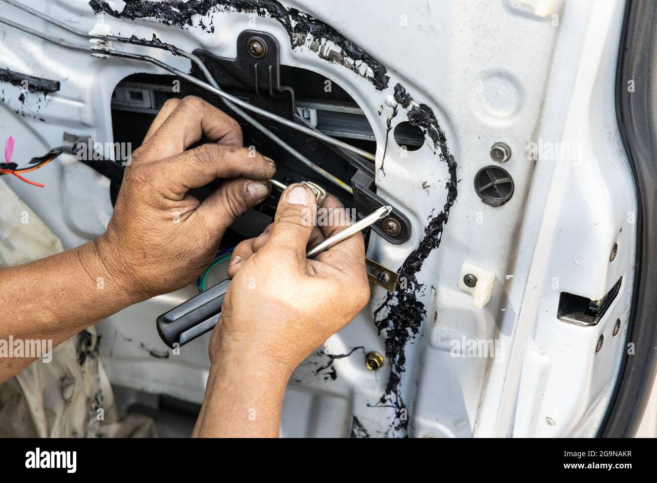 Auto technician diagnose and fixing wiring problem of car door Stock Photo Alamy