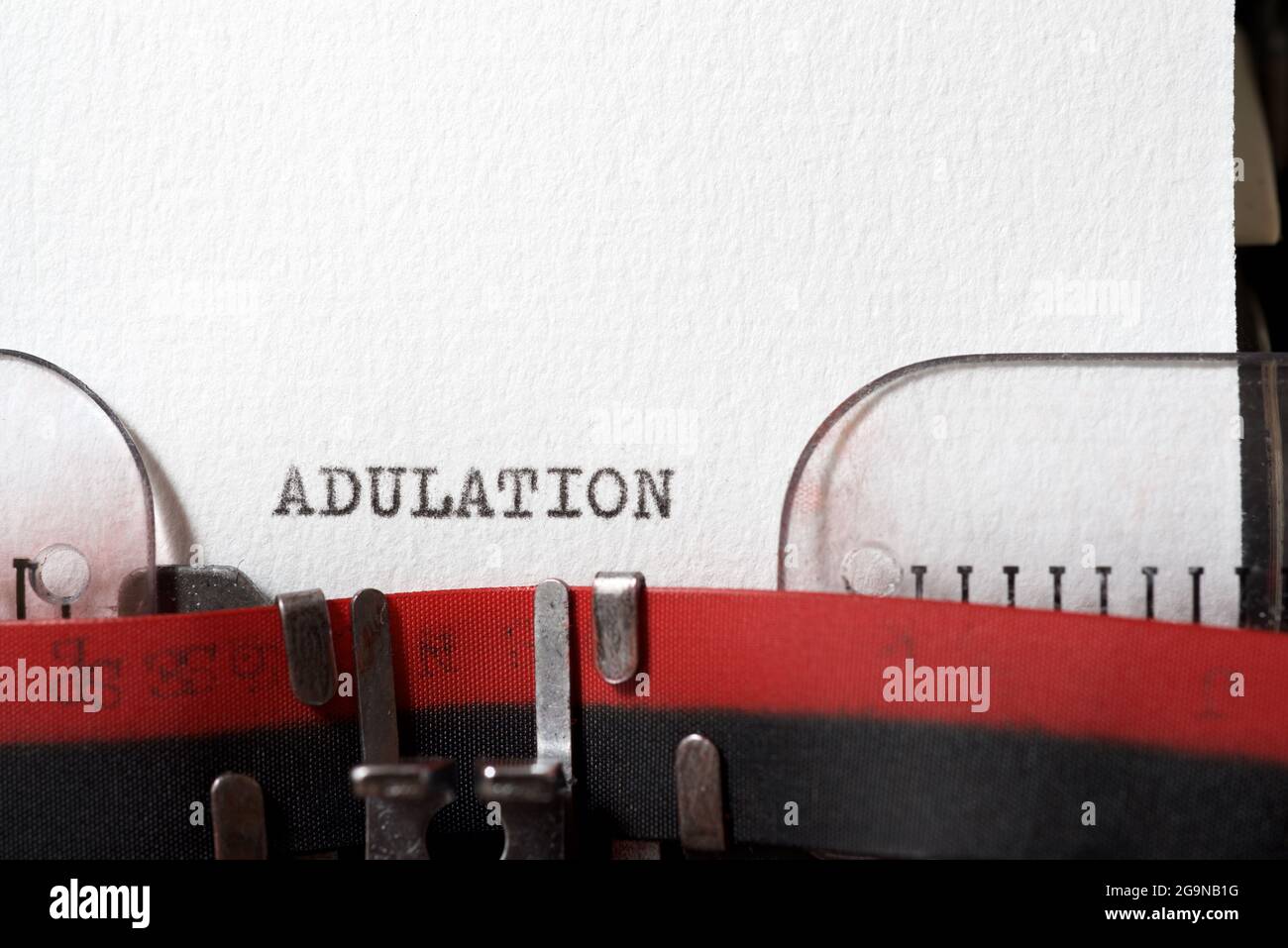 The word adulation written with a typewriter. Stock Photo