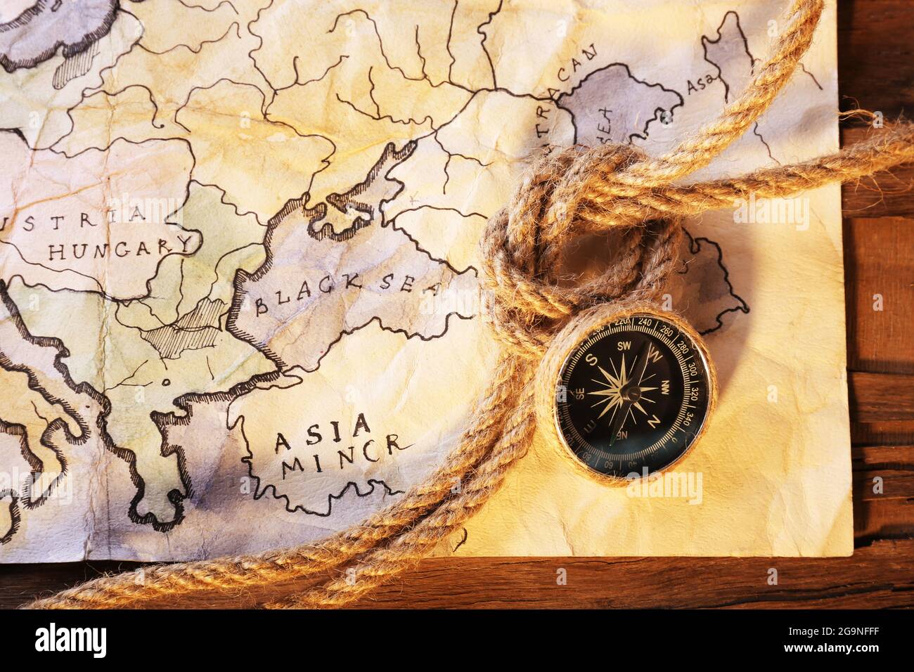 Still Life Map Marine still life with world map and rope on wooden table background ...