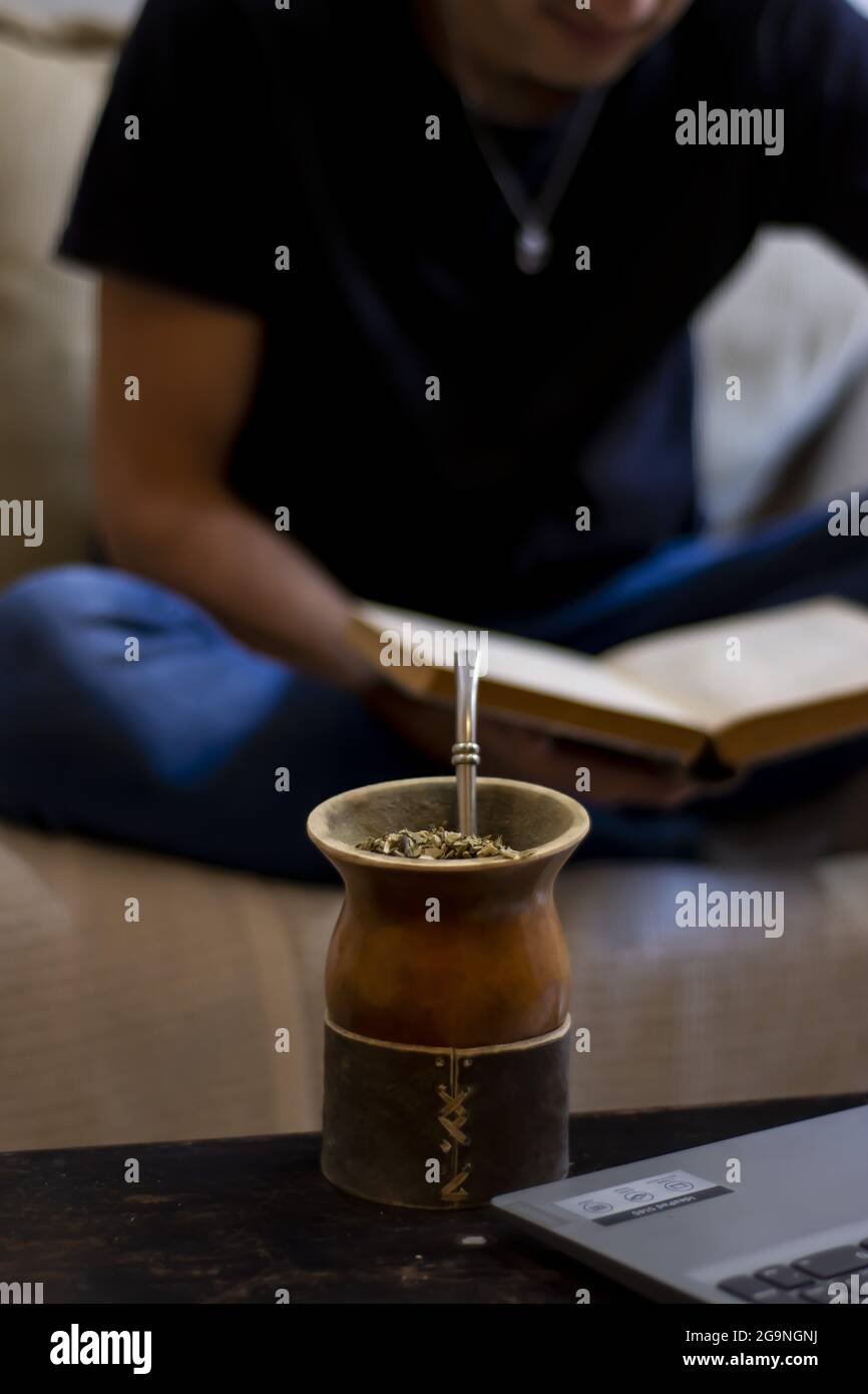 young man reading or working drinking mate Stock Photo