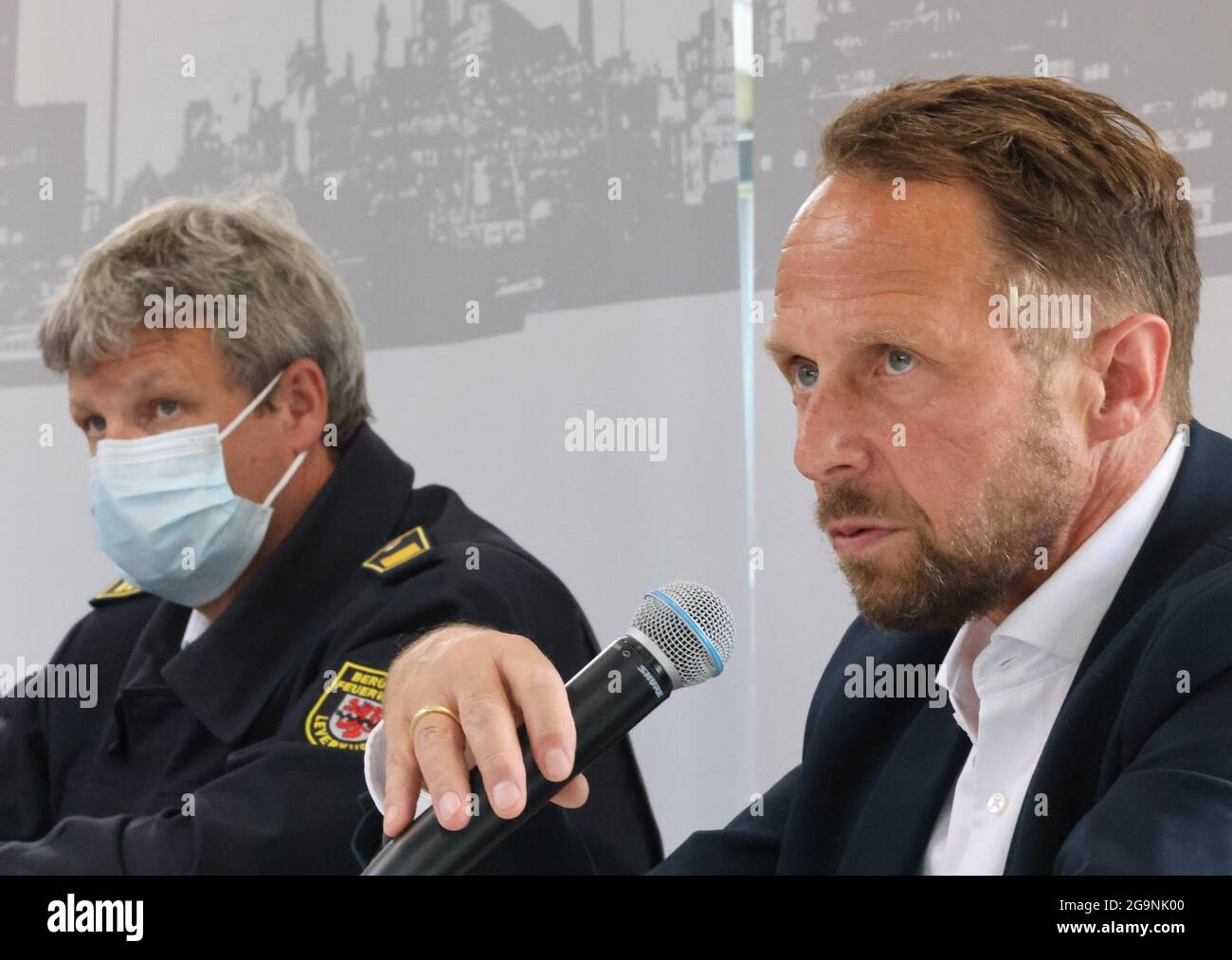 Leverkusen, Germany. 27th July, 2021. Uwe Richrath (SPD, r), Lord Mayor of Leverkusen, speaks next to Stephan Hummel, Head of Fire Protection at Currenta GmbH, at a press conference on the situation after the explosion at Chempark Leverkusen. After the devastating explosion at the Chempark with one dead and 16 injured there is still a hazardous situation. Credit: Oliver Berg/dpa/Alamy Live News Stock Photo