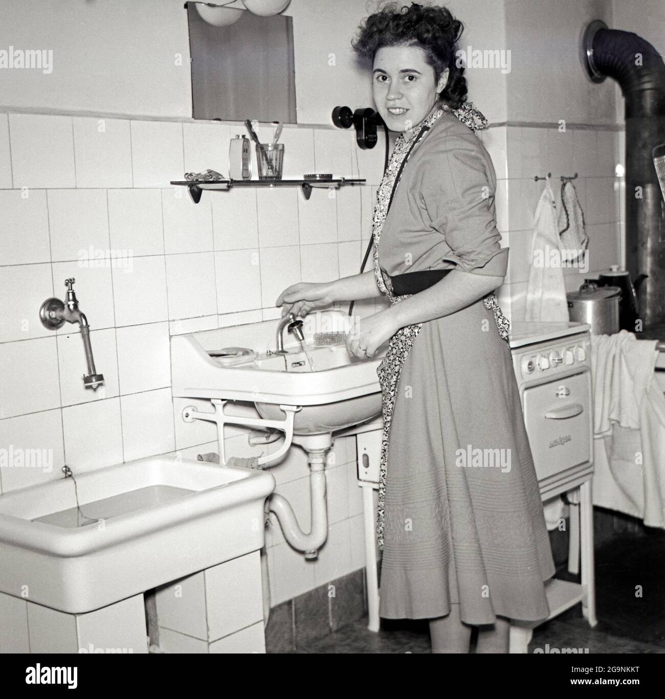 Housewife In The Kitchen Infront Of A Washbasin Europe Germany 
