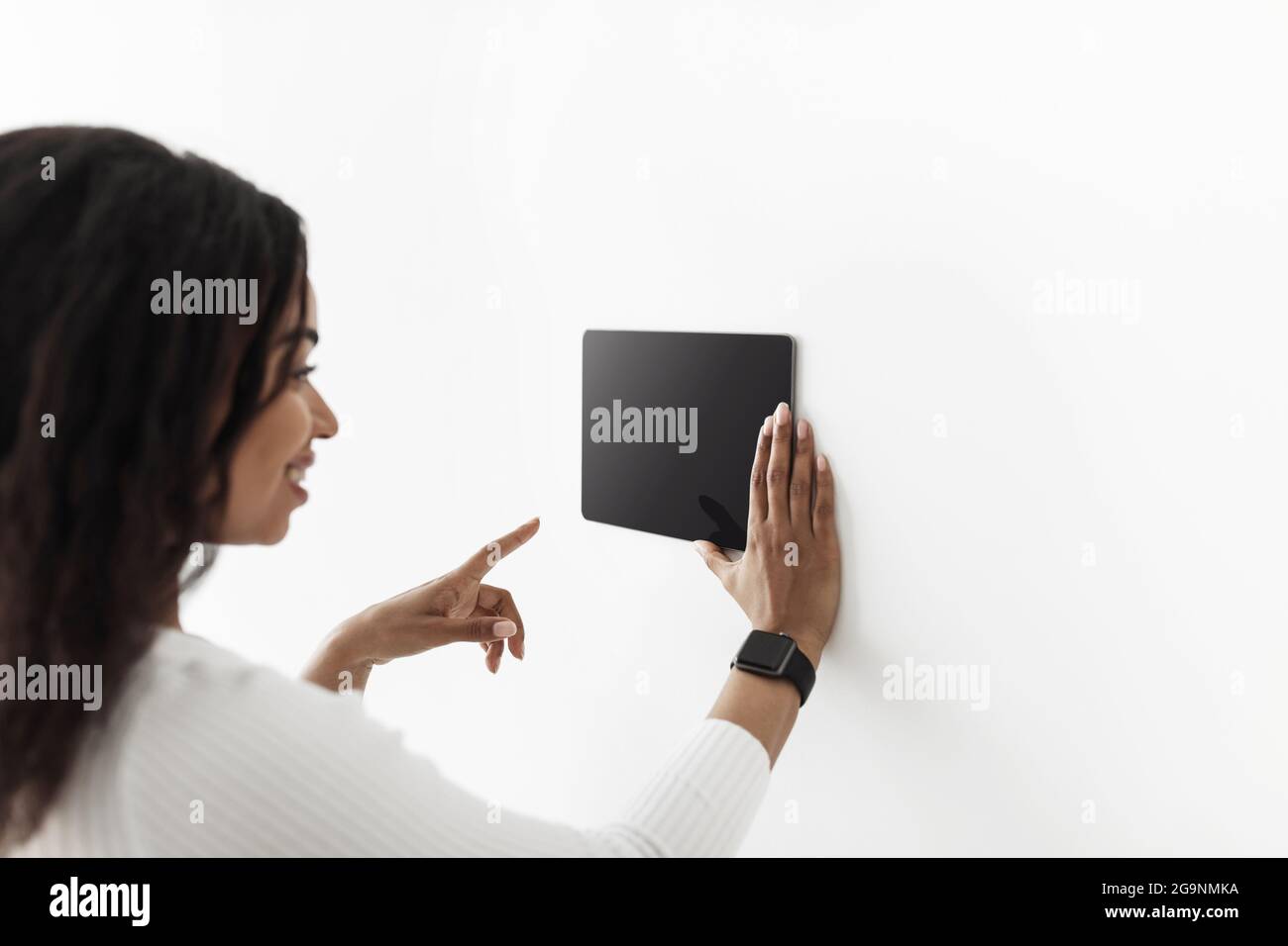 African american woman using digital tablet with blank black screen ...