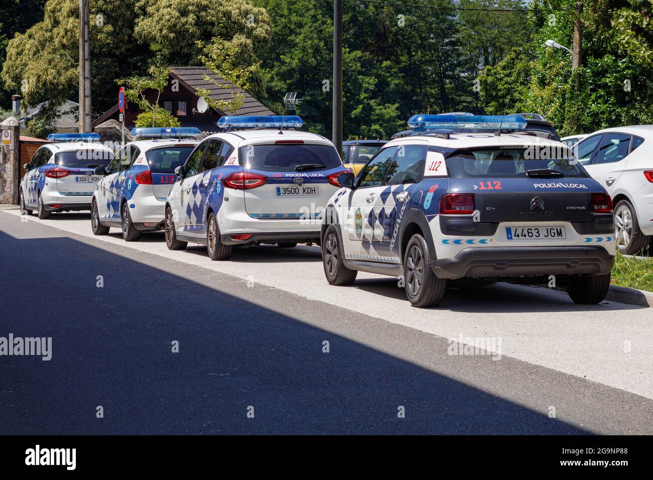 Coruna, Spain - July 09 2021: Four police cars parked in the sun outside Cambre local police station in La Coruna Spain Stock Photo