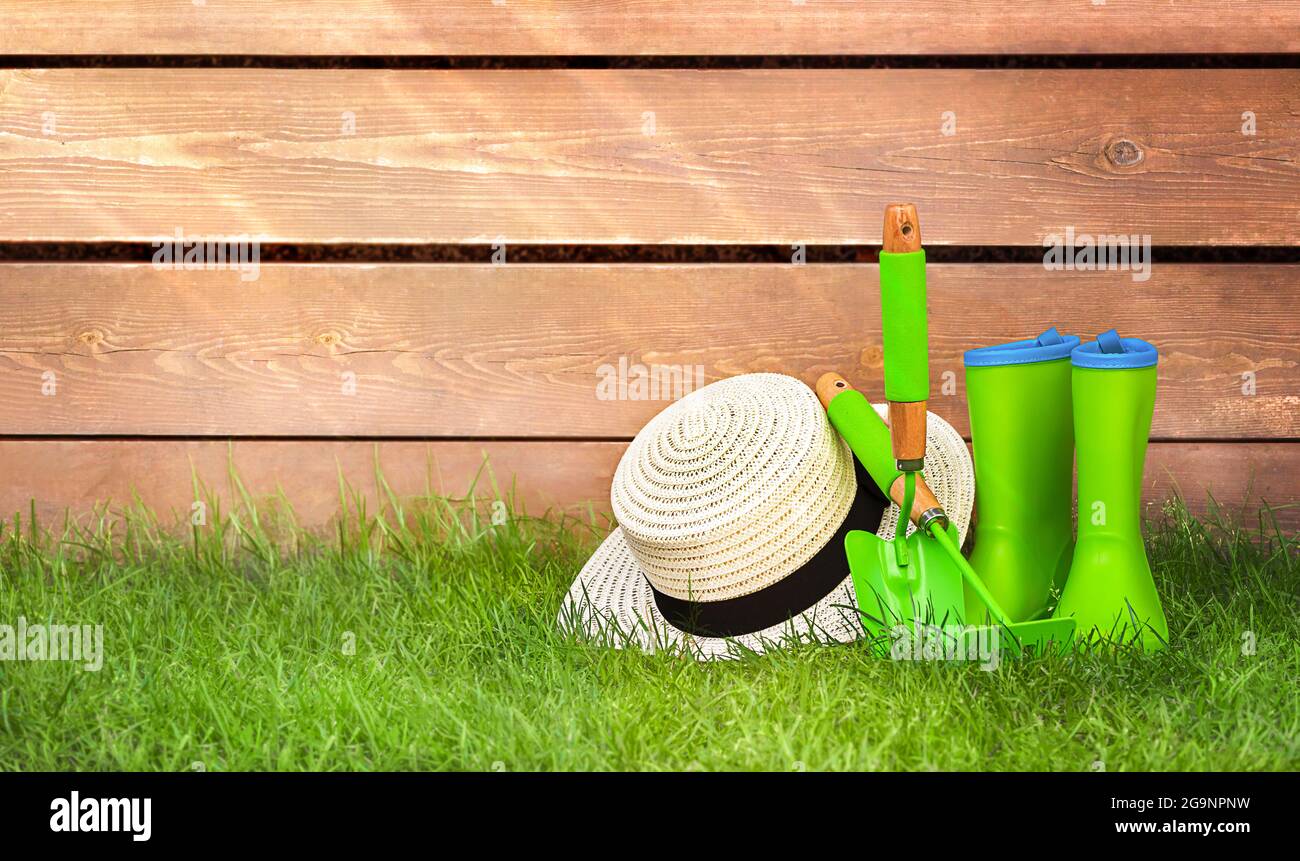 Wooden background with garden tools and a hat. Free space for your design Stock Photo