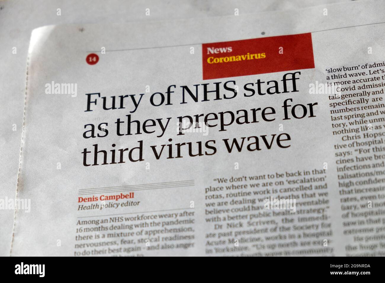 Newspaper article headline coronavirus news in the Guardian 'Fury of NHS staff as they prepare for third virus wave' London England UK  20 July 2021 Stock Photo