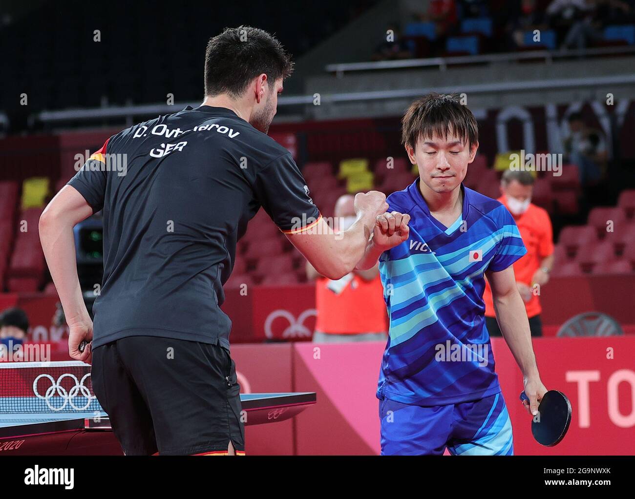 Tokyo, Japan. 27th July, 2021. Koki Niwa (R) of Japan greets his opponent, Dimitrij Ovtcharov of Germany after losing the table tennis men's singles round of 16 match at the Tokyo 2020 Olympic Games in Tokyo, Japan, July 27, 2021. Credit: Wang Dongzhen/Xinhua/Alamy Live News Stock Photo