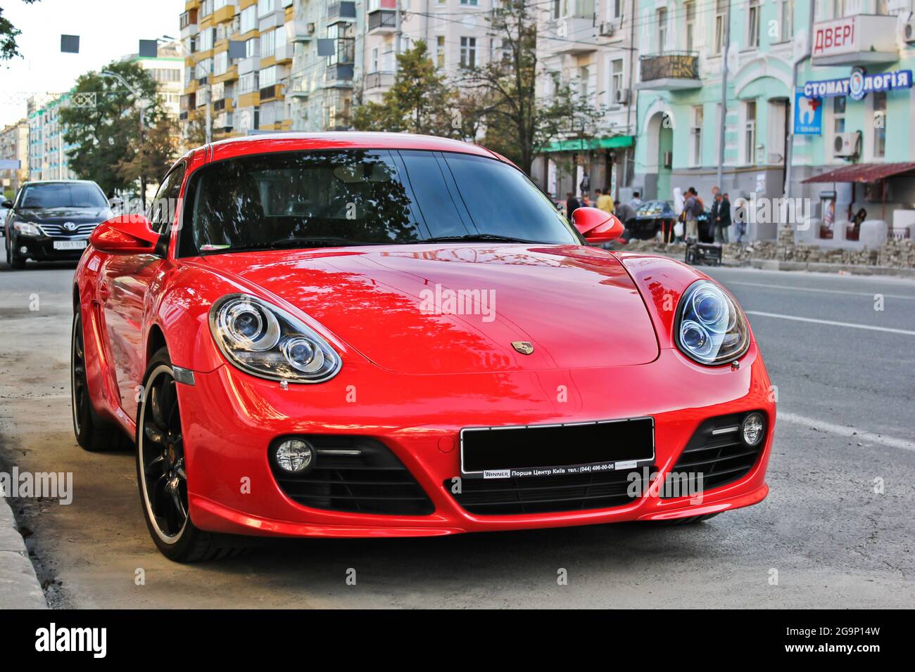 Kiev, Ukraine - July 3, 2013: Red Porsche Cayman S parked in the city Stock Photo