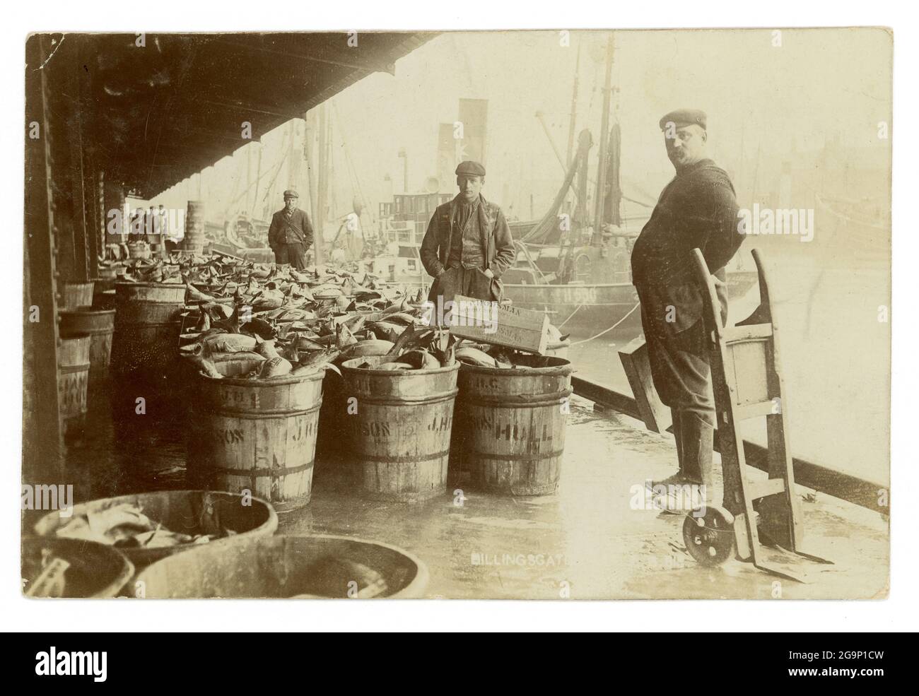 Early 1900's image of fishmongers at the old Billingsgate Fish Market, with a huge quantity of fish in crates, London, U.K.  circa 1910 Stock Photo
