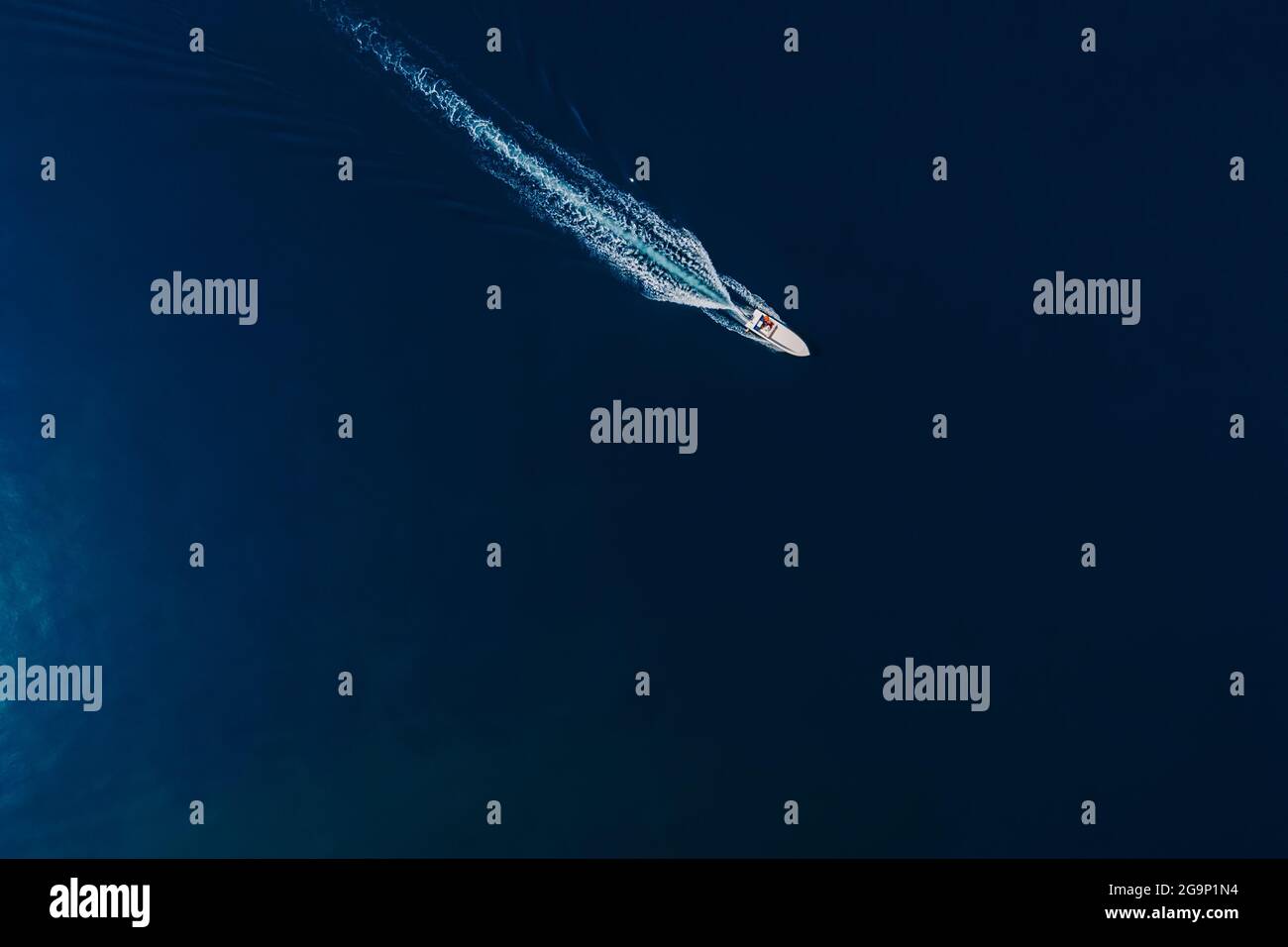 Speedy motor boat is sailing in ocean. Aerial view Stock Photo