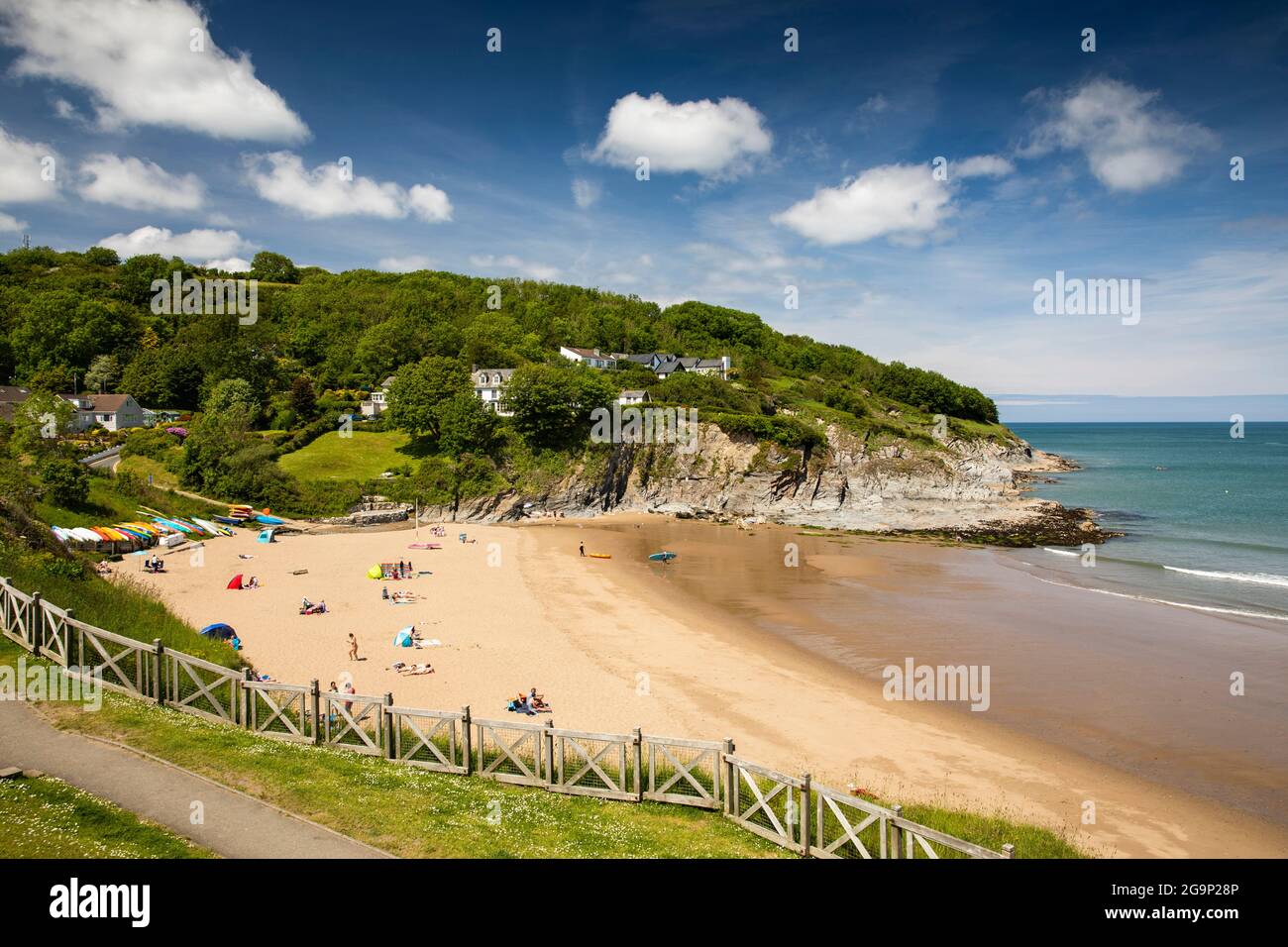 UK, Wales, Ceredigion, Aberporth, visitors on beach below Trecregyn Stock Photo