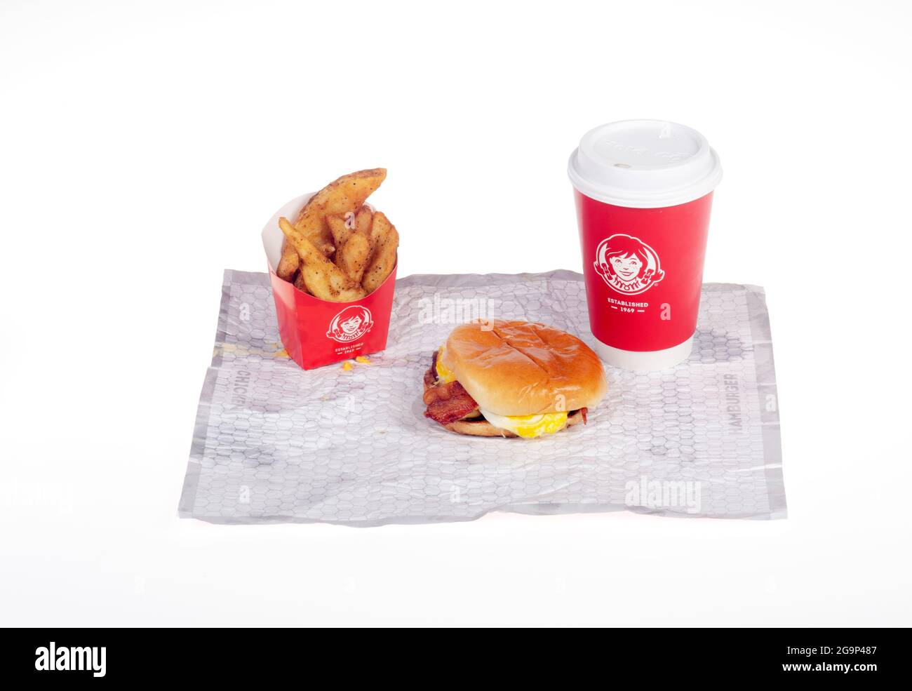 Wendy's bacon, egg, cheese breakfast Sandwich with Seasoned Potatoes & Coffee Cup on wrapper Stock Photo