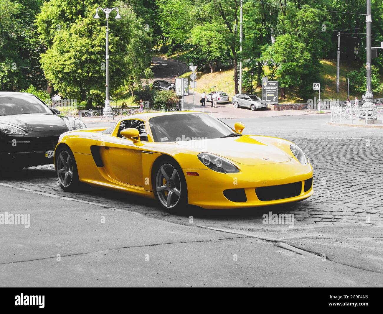 Kiev, Ukraine - June 12, 2011: Exclusive supercar Porsche Carrera GT is  parked in the city. Yellow Porsche Stock Photo - Alamy