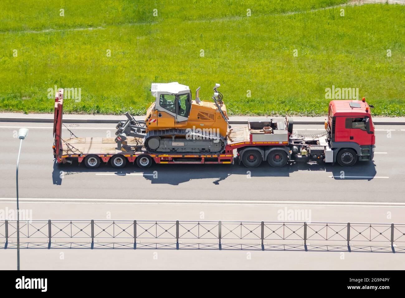 Earth mover backhoe on heavy duty flatbed vehicle for transported