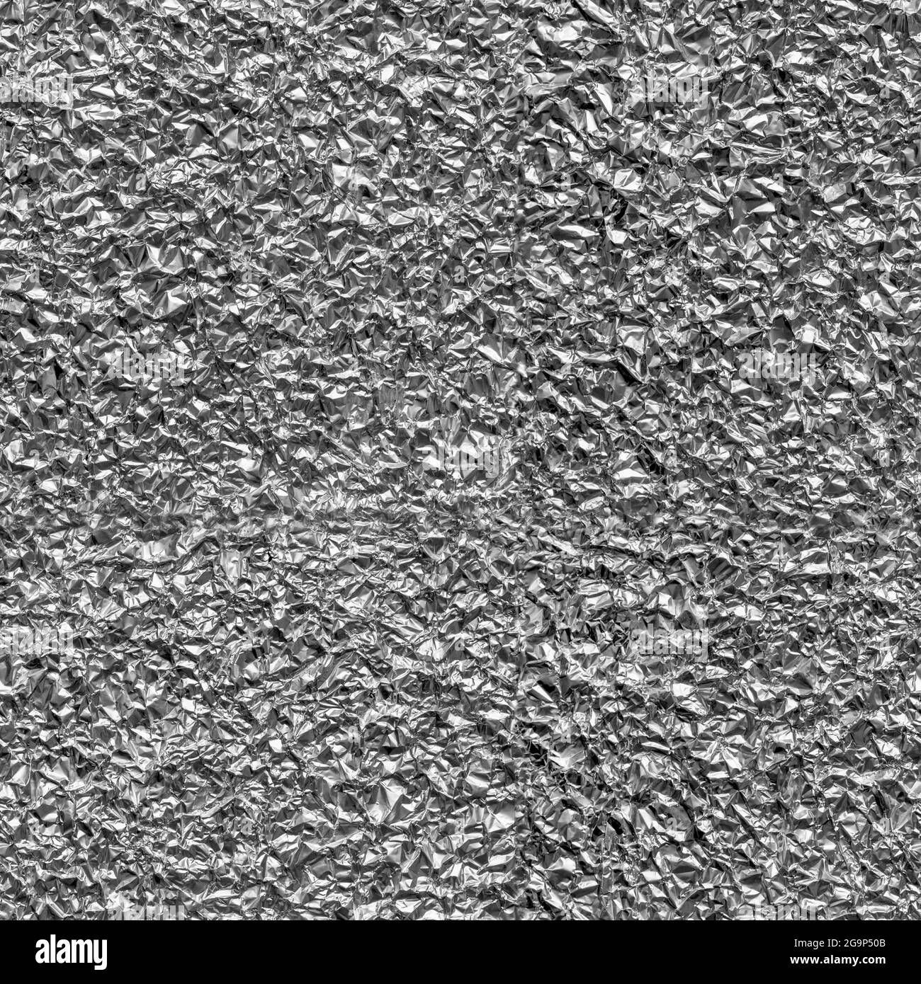 Seamless texture of crumpled aluminum leaf foil, close-up. Stock Photo