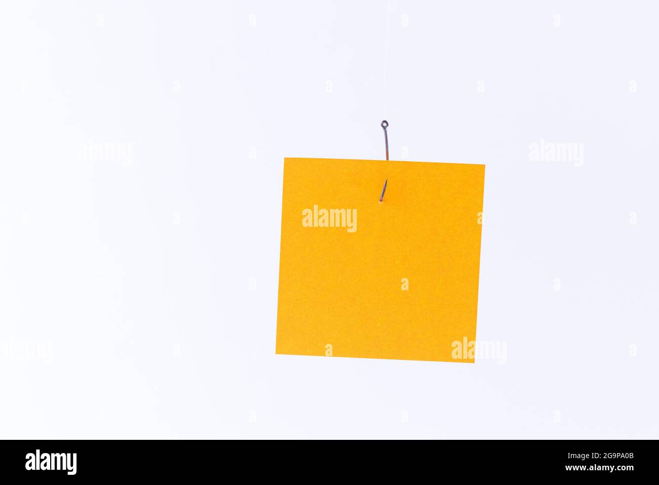 Mockup of a Blank Orange Memo Paper with Copy Space Hanging on a