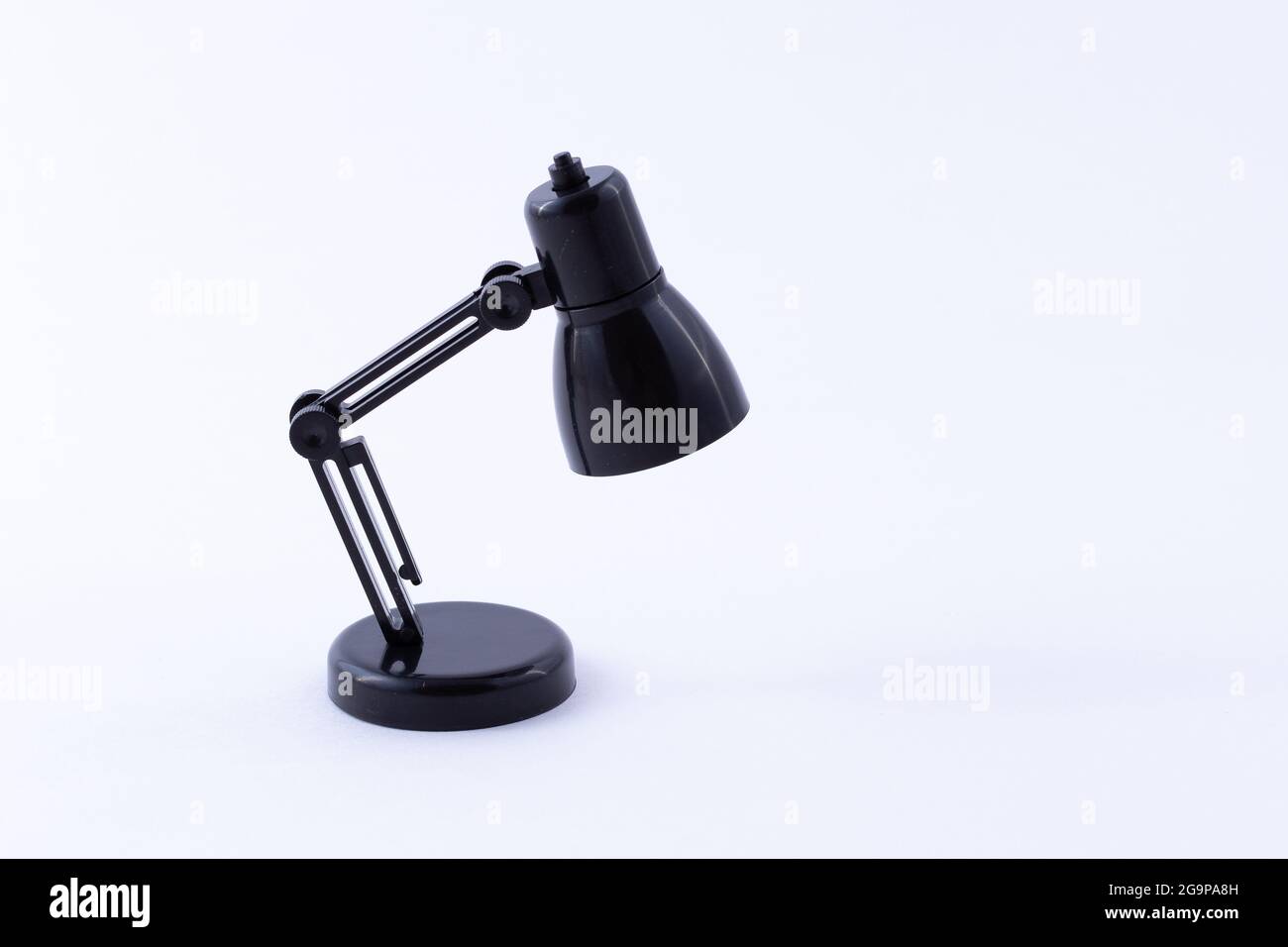 Table Lamp Mini Model. Small Black Desk Lamp on White Background Stock Photo