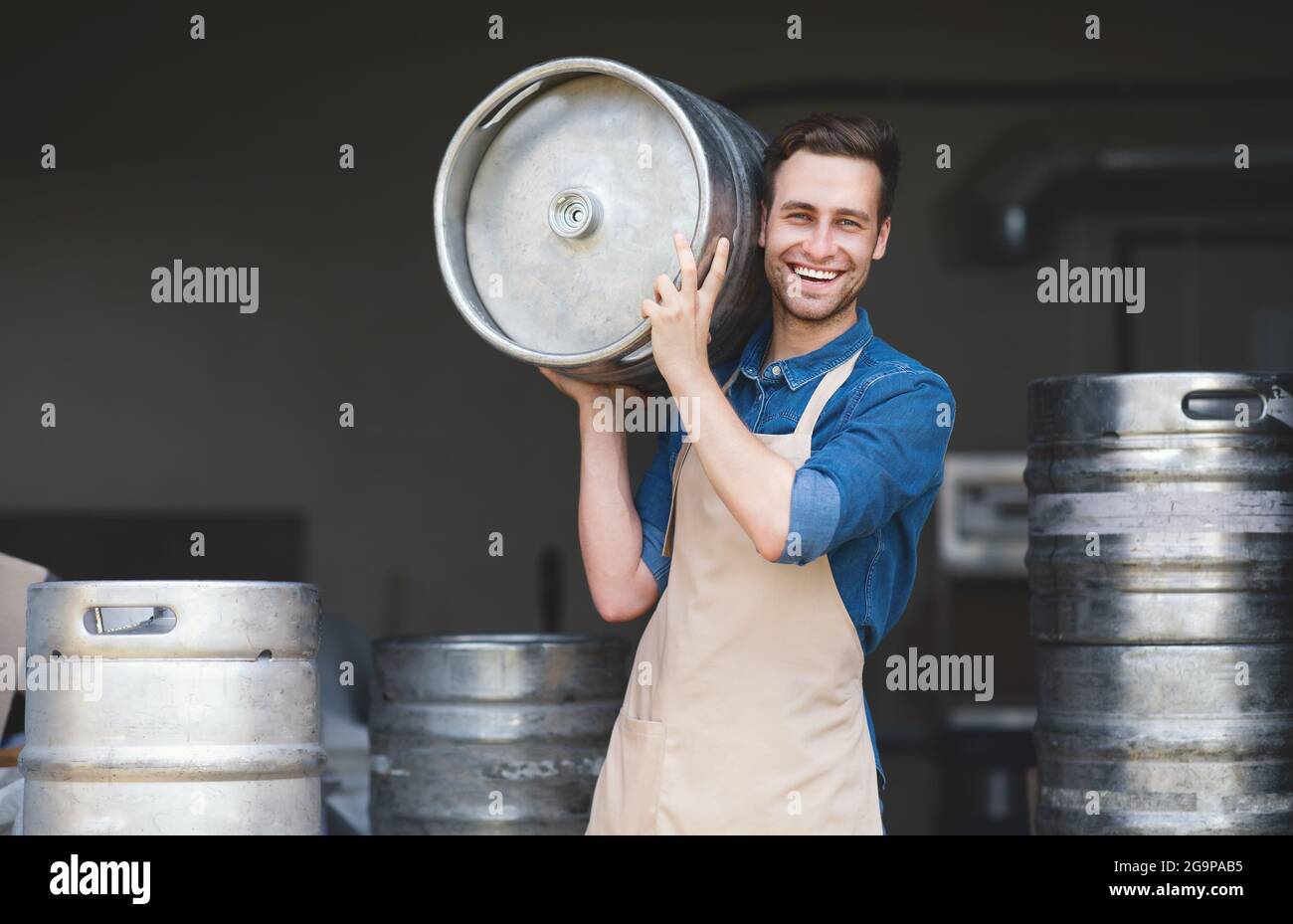 Brewery, work in warehouse, modern strong worker brewer loads ingredients Stock Photo