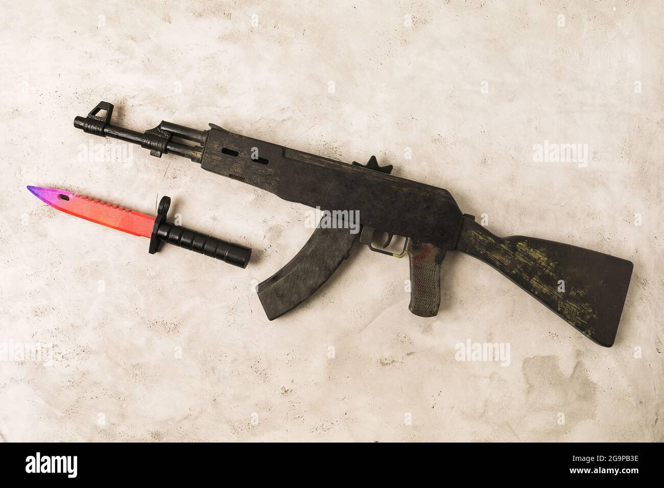 Toy machine gun and bayonet knife made of wood, top view Stock Photo - Alamy