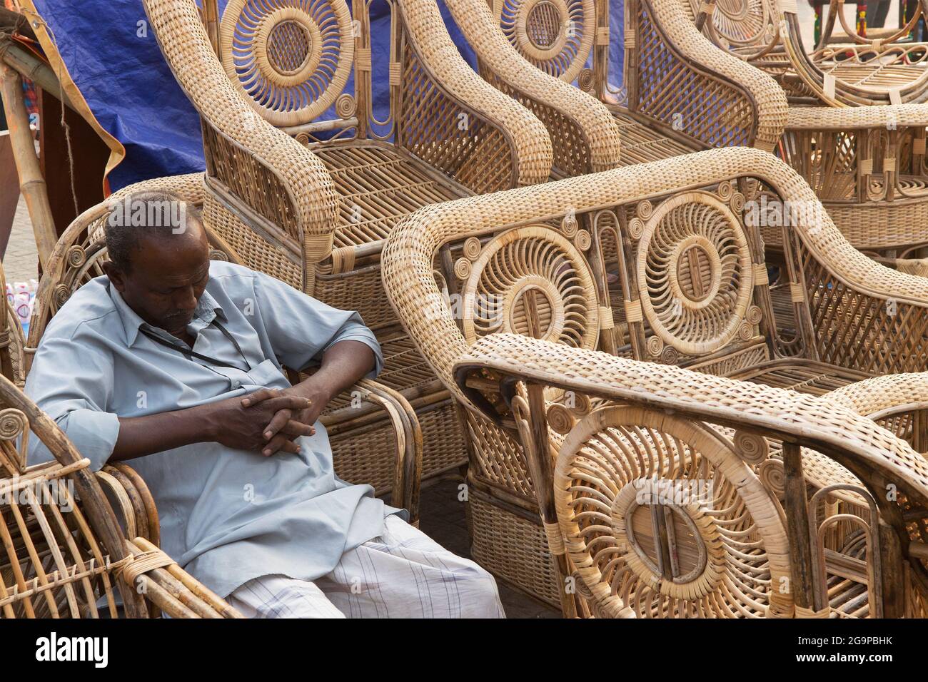 KOLKATA, WEST BENGAL , INDIA - NOVEMBER 23RD 2014 : Unidentified man sleeping with cane furnitures , Handicraft Fair in Kolkata . Stock Photo