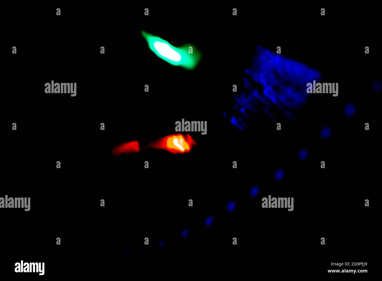 colored bokeh lights sparkling on black background Stock Photo