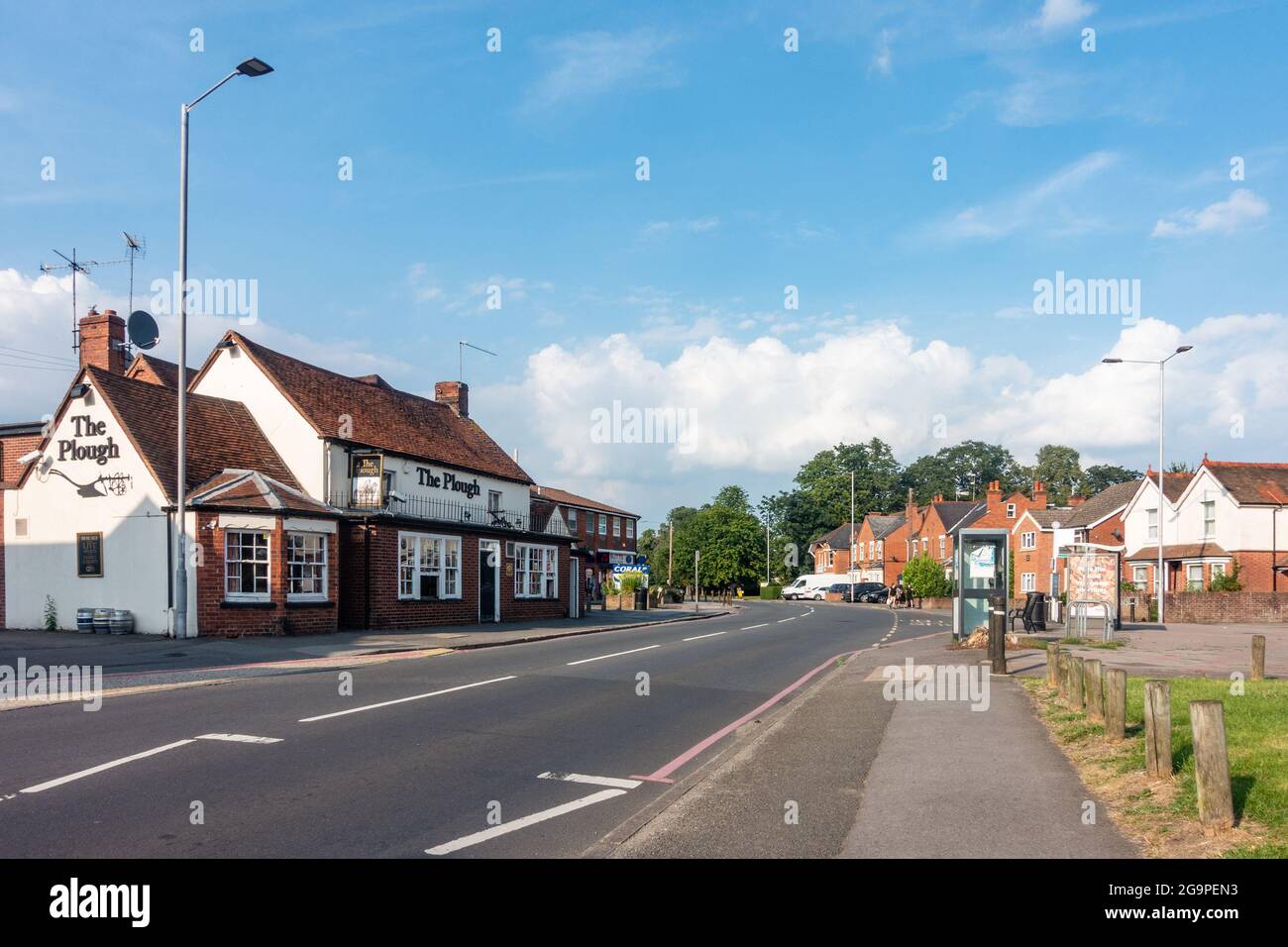 A view along School Road in Tilehurst, Reading, UK with The Plough pub on the side of the road. Stock Photo