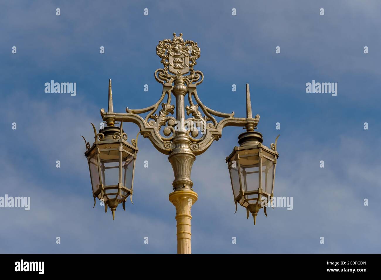 An ornate victorian street lamps on the seafront in Brighton, Sussex, England, UK against a cloudy blue sky. Stock Photo