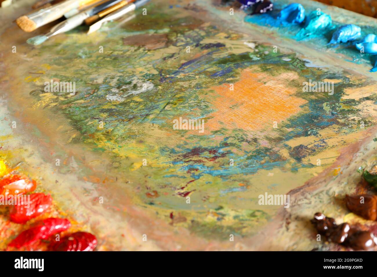 Acrylic paint with brushes on wooden palette Stock Photo Alamy