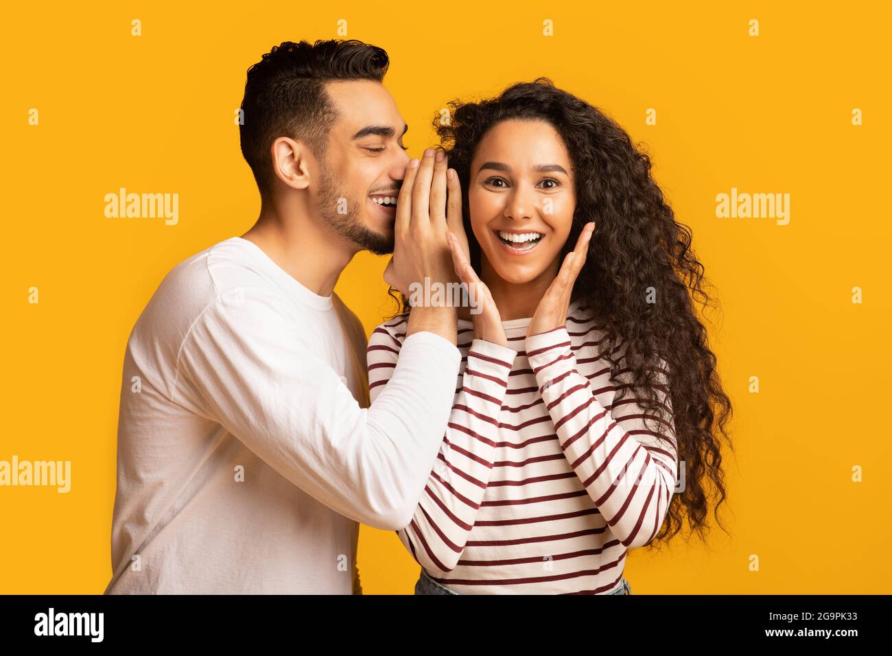 Big Secret. Young Arab Man Sharing News With His Excited Girlfriend Stock Photo