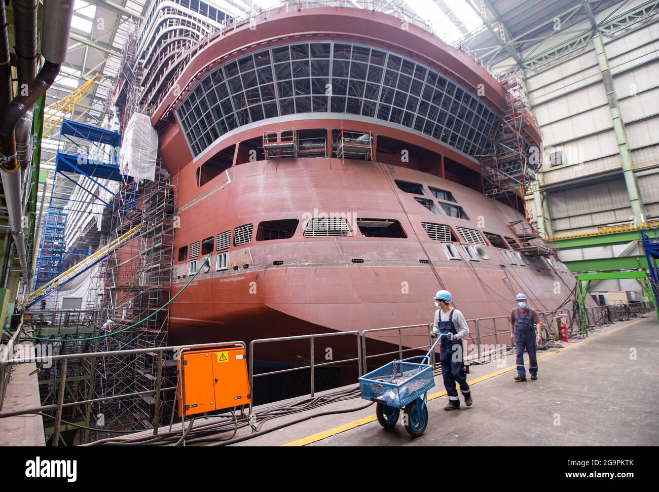 Wismar Germany 14th July 2021 Shipbuilders Watch The Assembly Of The Ship S Propulsion System At The Stern Of The Global Dream Cruise Ship Under Construction In The Dock Of The Mv Shipyard