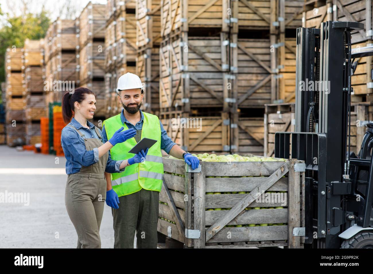 Warehouse management, loading fruit for dispatch and storage, production and sale Stock Photo