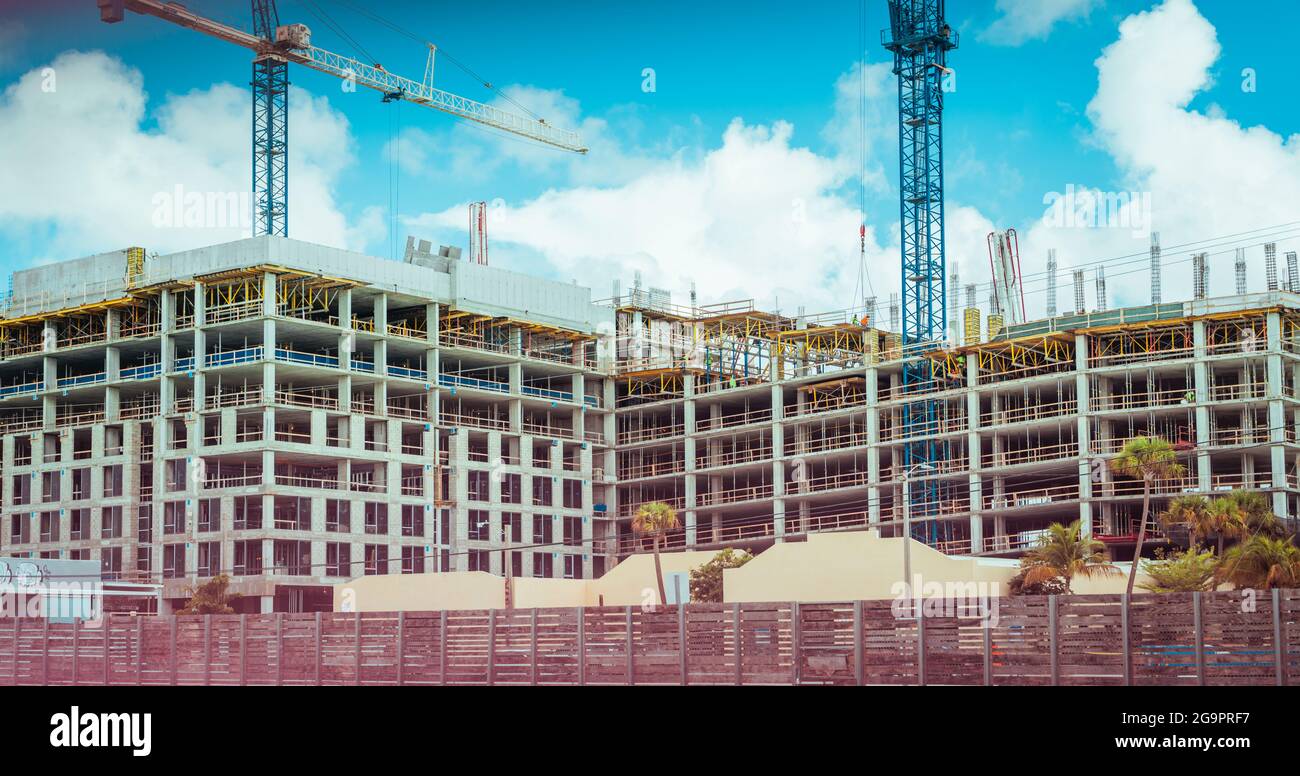 Construction site with tower cranes under a cloudy sky Stock Photo - Alamy