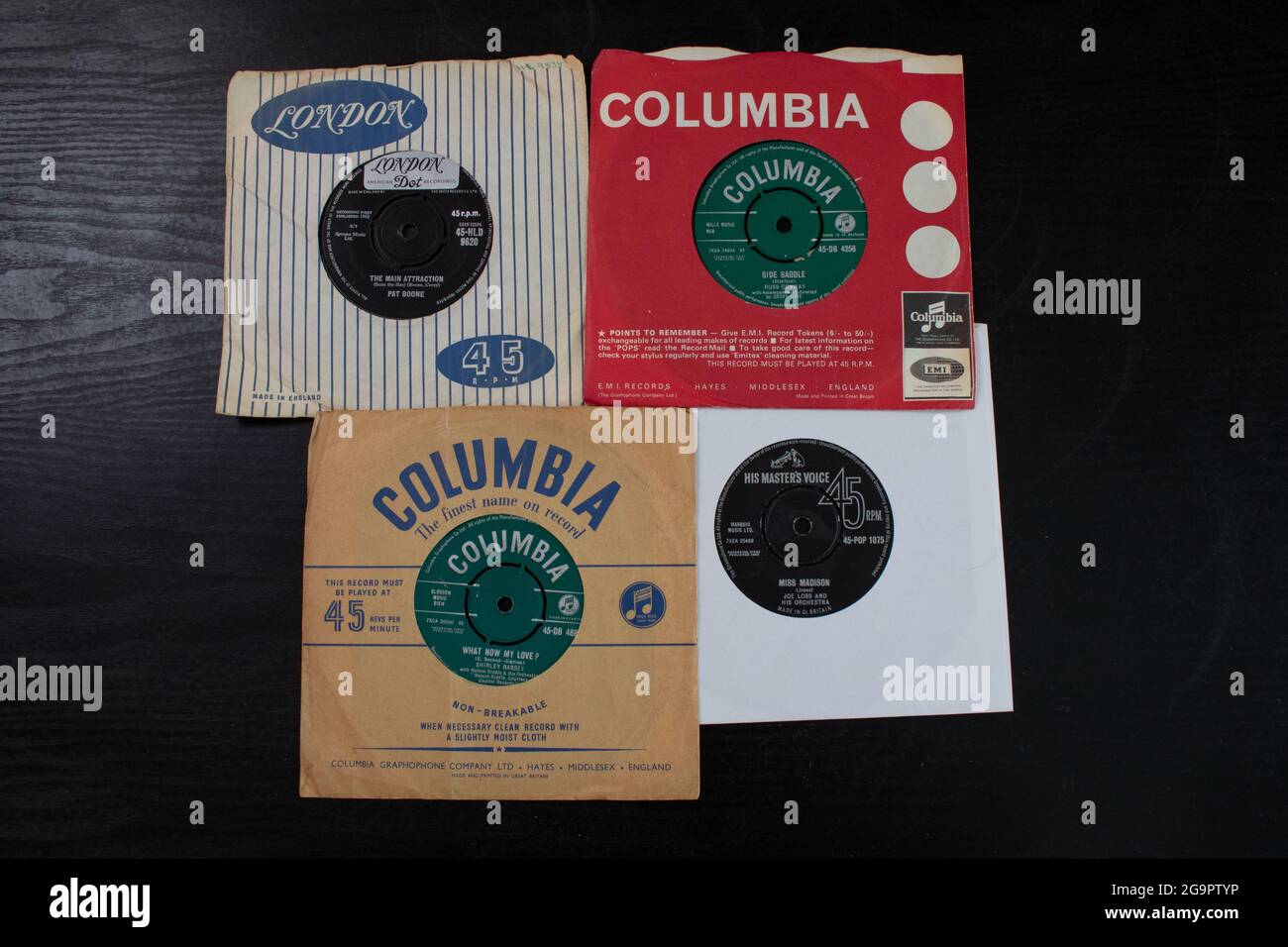 Four 45 singles from the 1950s and 1960s by artists Pat Boone, Shirley Bassey, Joe Loss and Russ Conway. Stock Photo