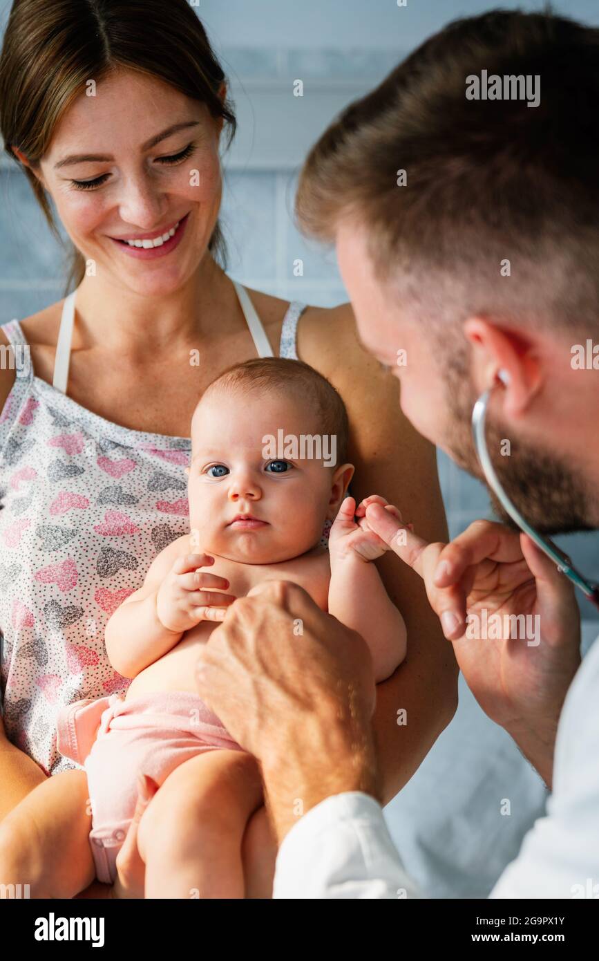 Pediatric doctor exams little baby. Health care, medical examination, people concept Stock Photo