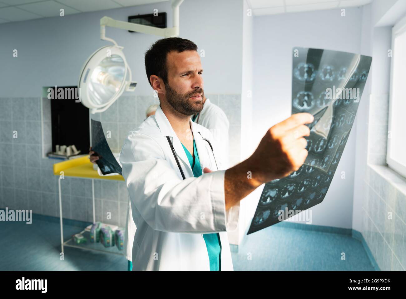 Radiologist, doctor examining xray images of patient for diagnosis