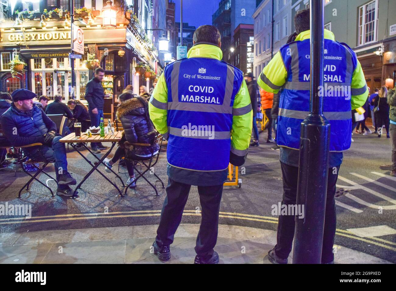 Covid marshals on patrol in Old Compton Street, Soho, at night. London, United Kingdom, April 2021. Stock Photo
