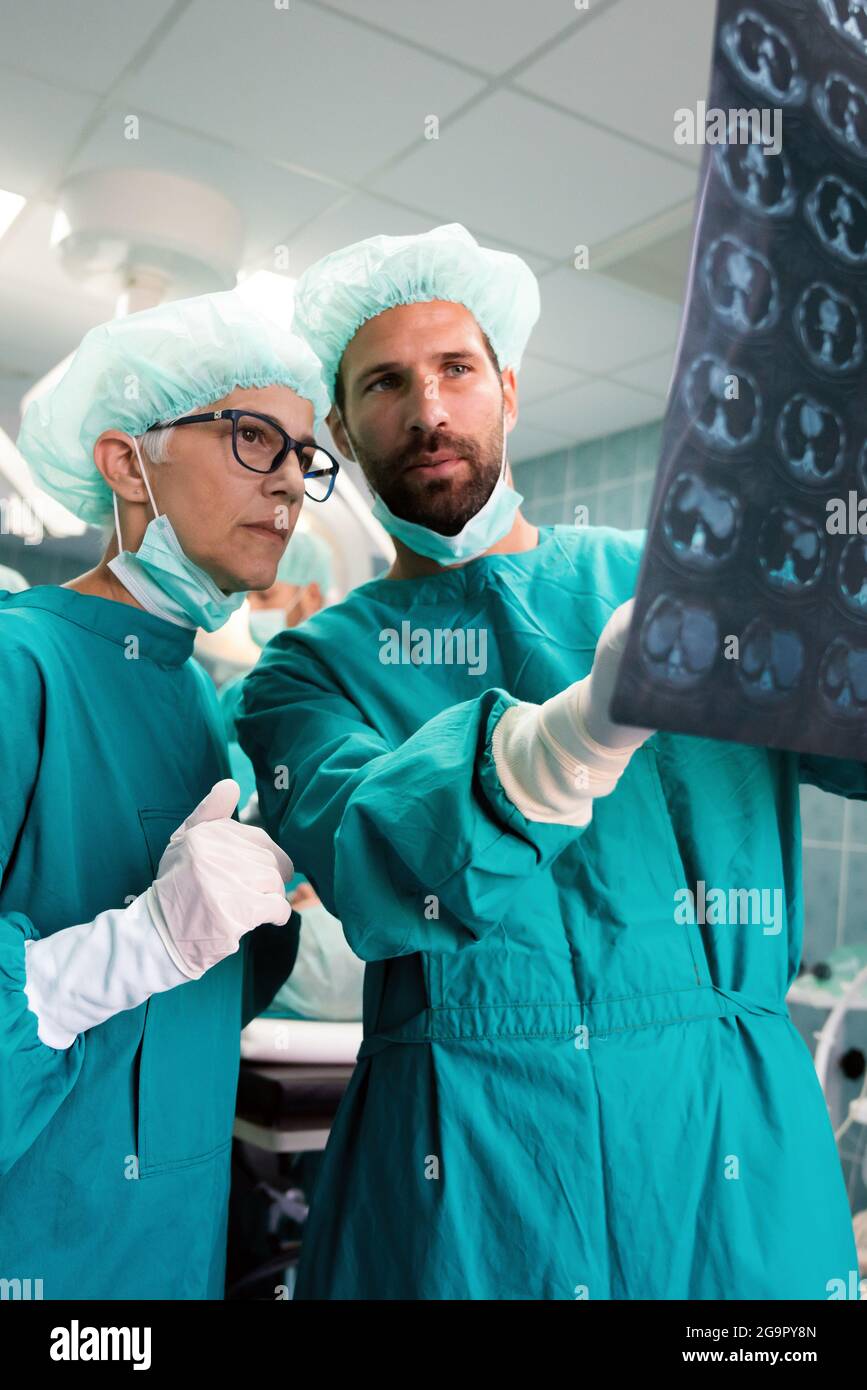 Doctors examining x-ray images of patient for diagnosis. Healthcare, surgery, radiology concept Stock Photo