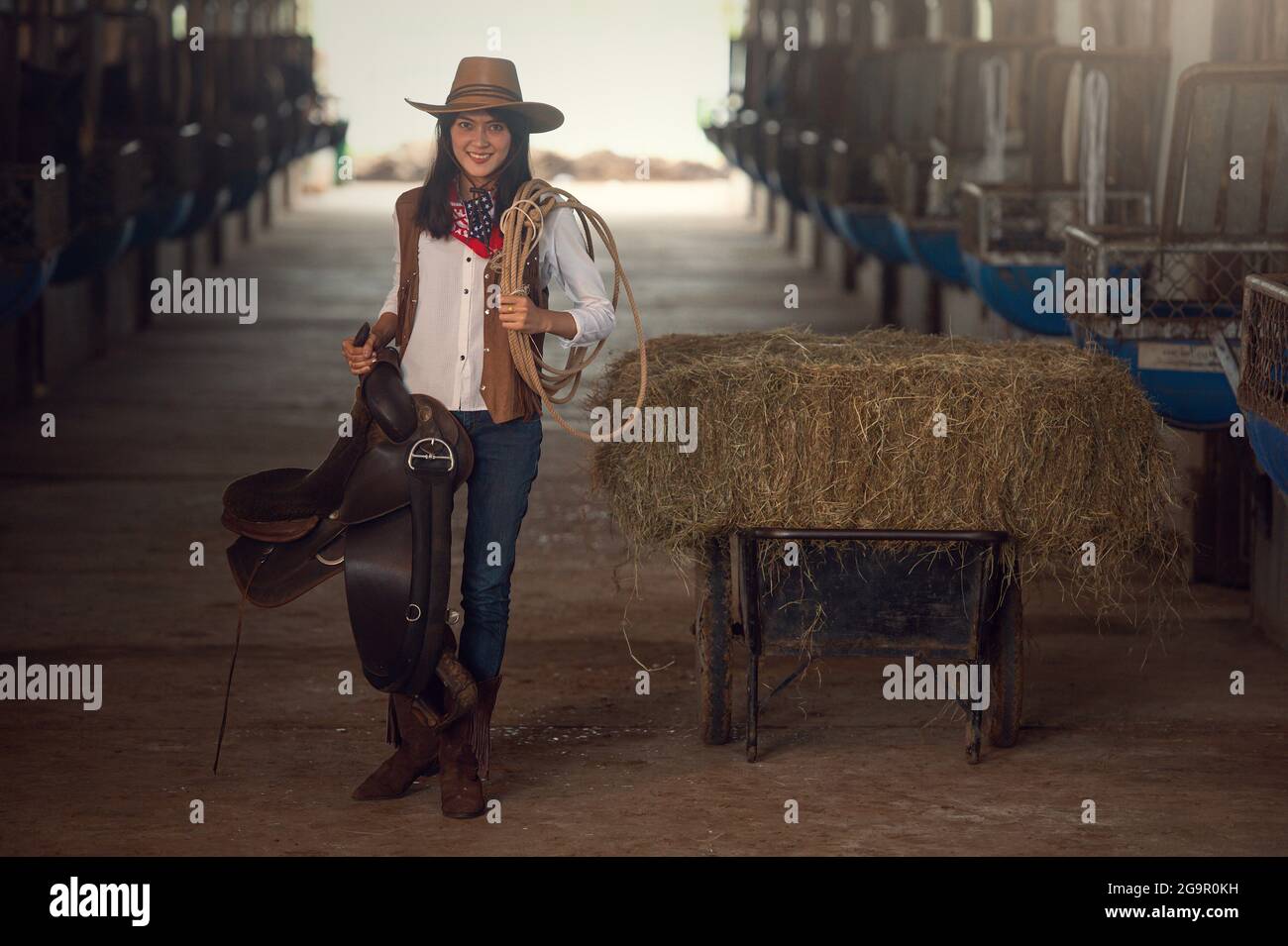 Cowgirl working stables.Concept of retro woman in horse ranch.vintage style Stock Photo