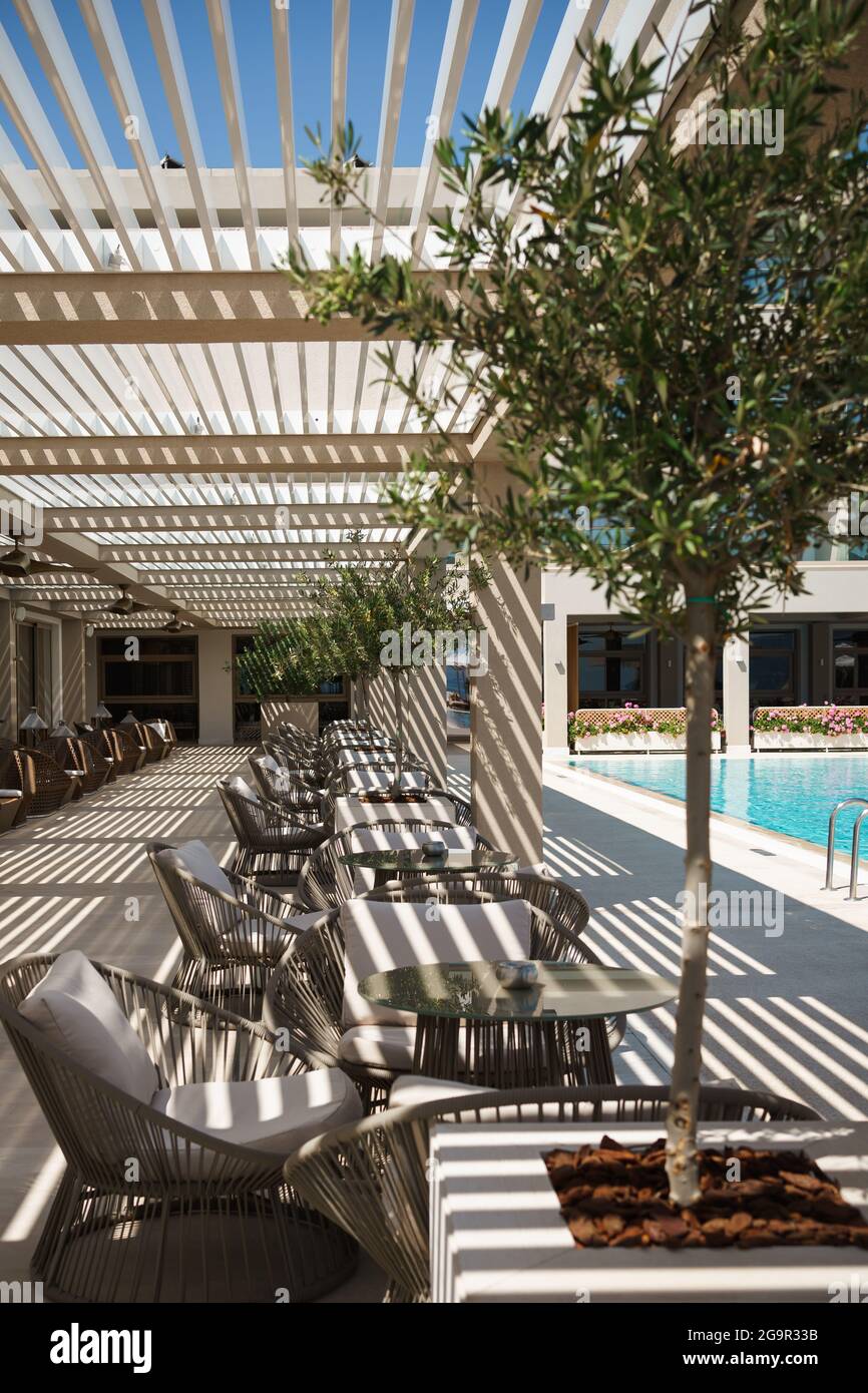 tables and chairs in a cafe under a canopy Stock Photo Alamy
