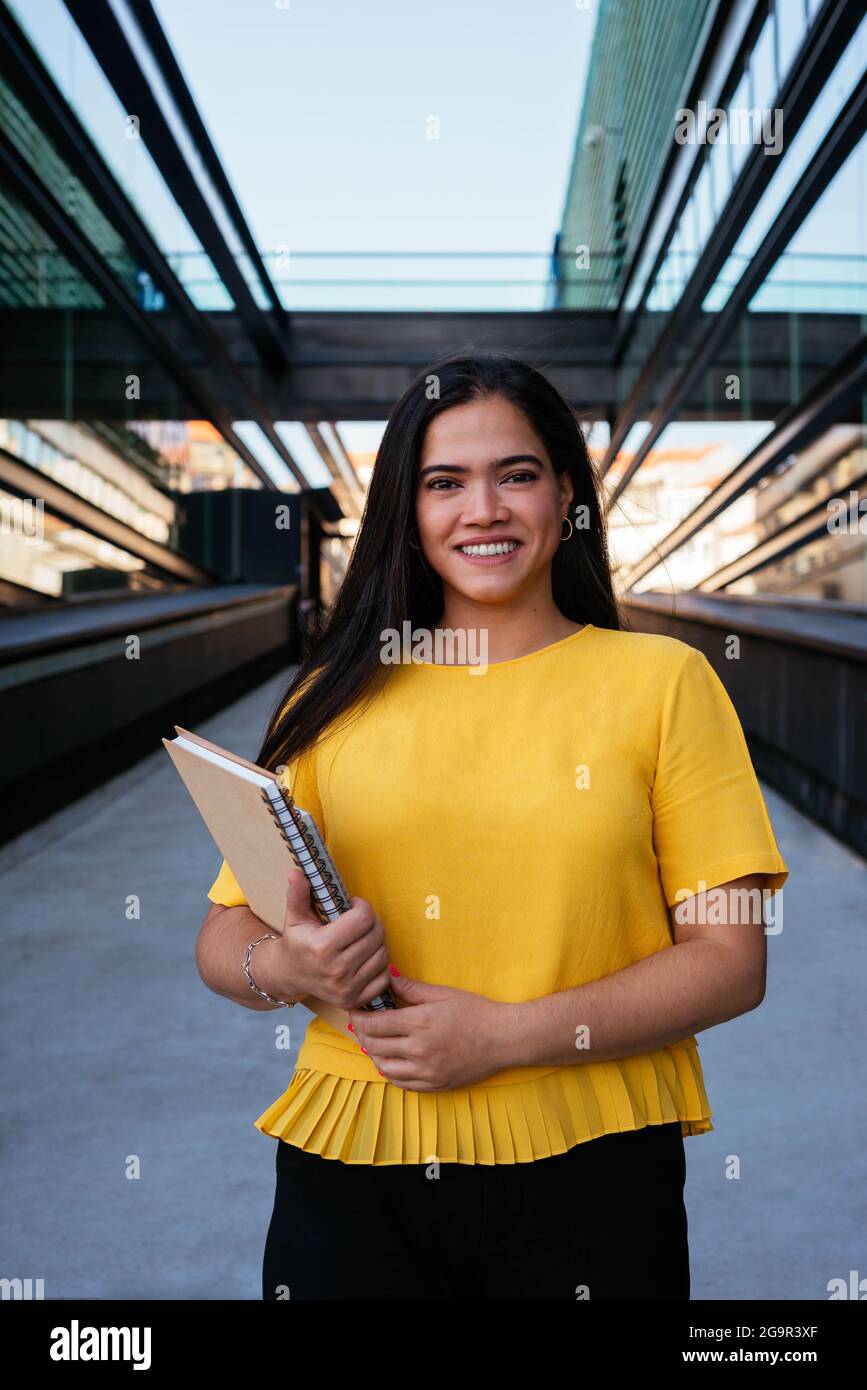 Portrait of a young business woman smiling at camera in business ...