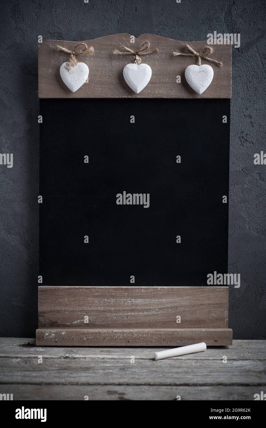Wooden blackboard and white chalk on concrete background. Menu concept