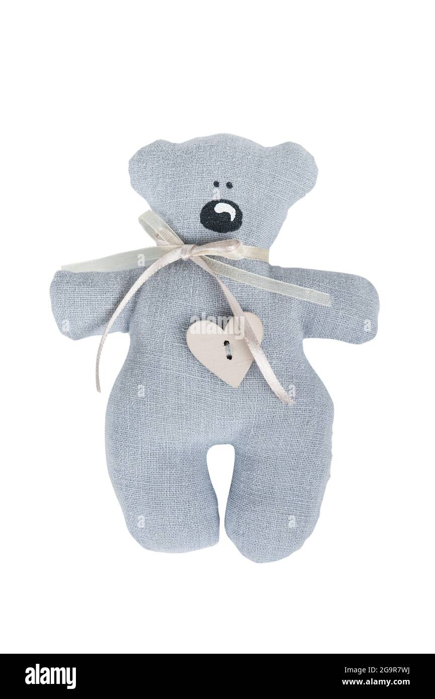 Grey teddy bear with wooden heart button isolated on white background ...
