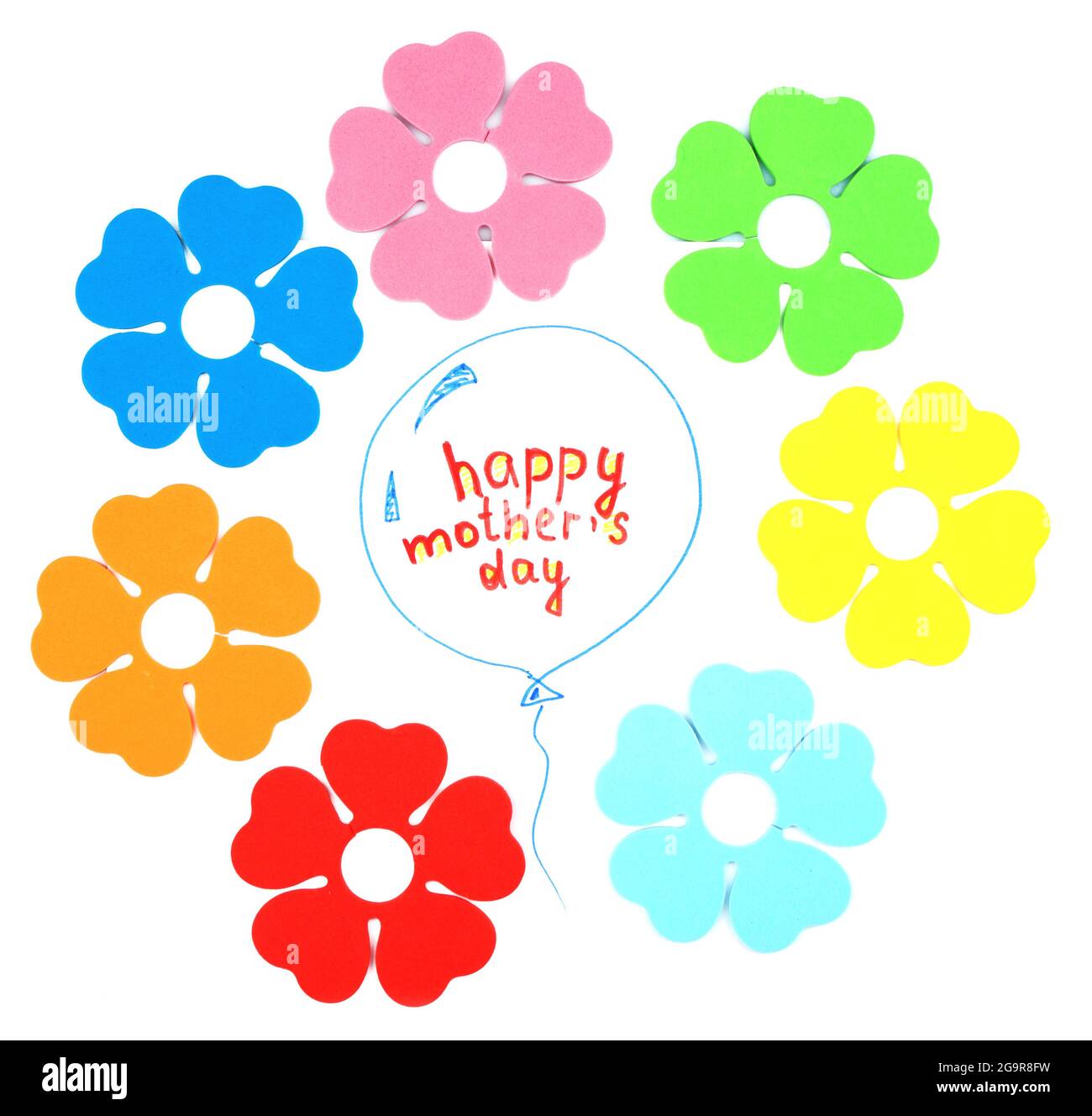 Happy Mothers Day message written on paper and decorative flowers