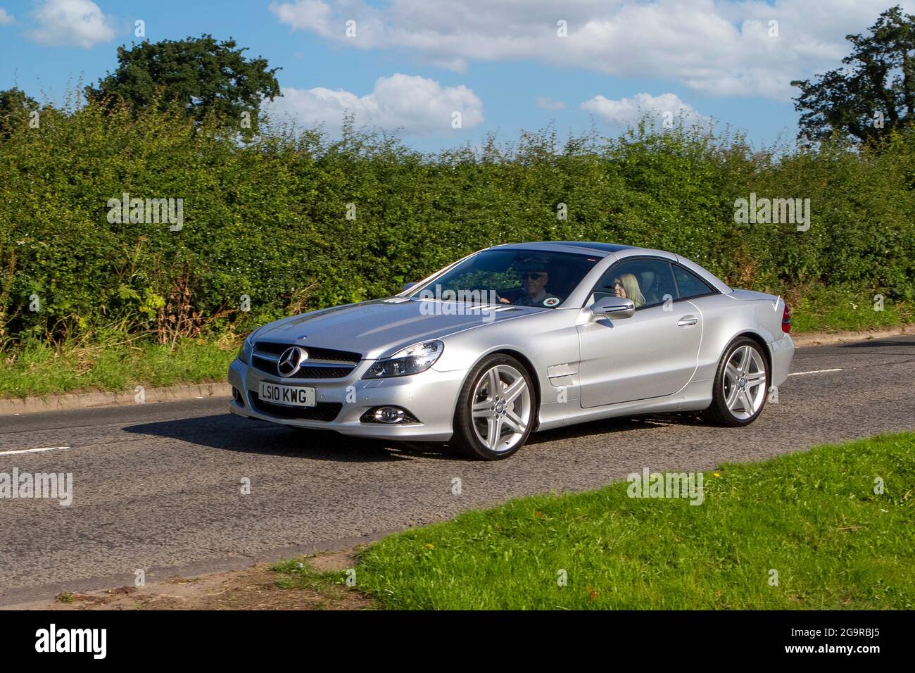 2010 silver Mercedes Benz 350 7 speed automatic vehicle en-route to Capesthorne Hall classic July car show, Cheshire, UK Stock Photo