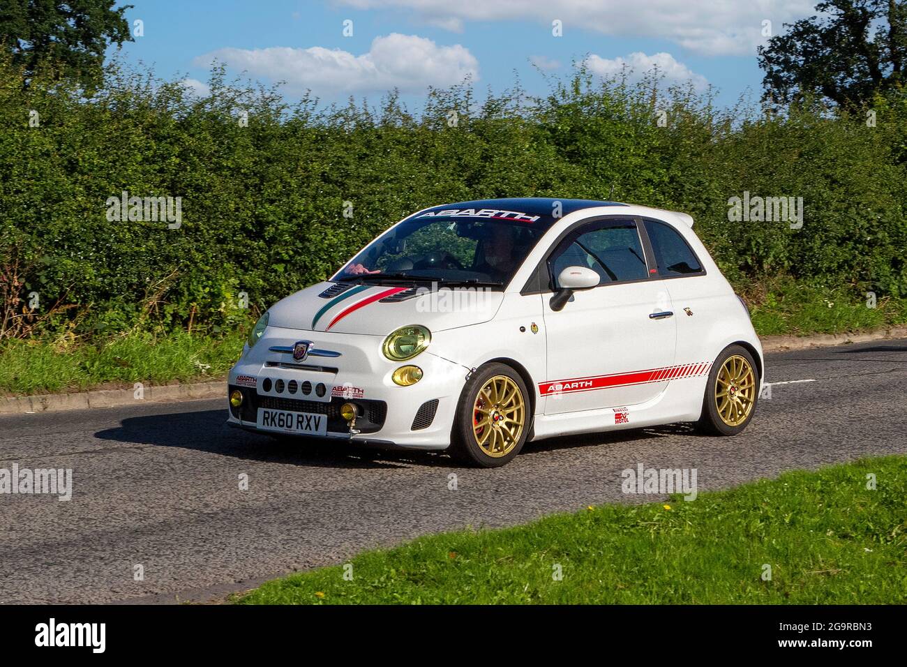 2010 white Fiat Abarth 2dr 1368cc small vehicle en-route to Capesthorne Hall classic July car show, Cheshire, UK Stock Photo