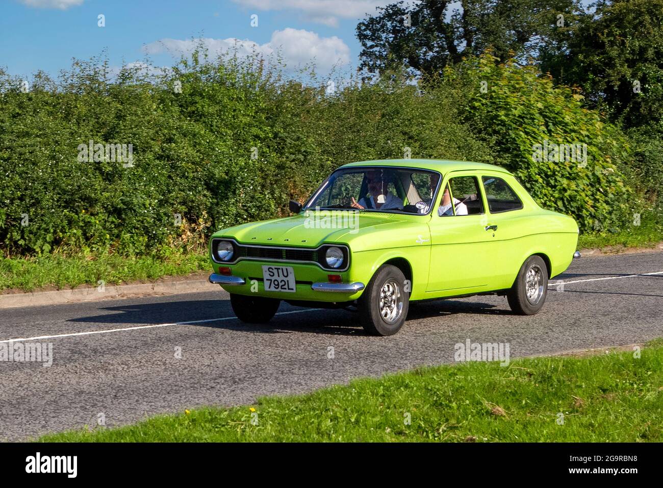 1973 70s green Ford Escort 2dr saloon vehicle en-route to Capesthorne Hall classic July car show, Cheshire, UK Stock Photo