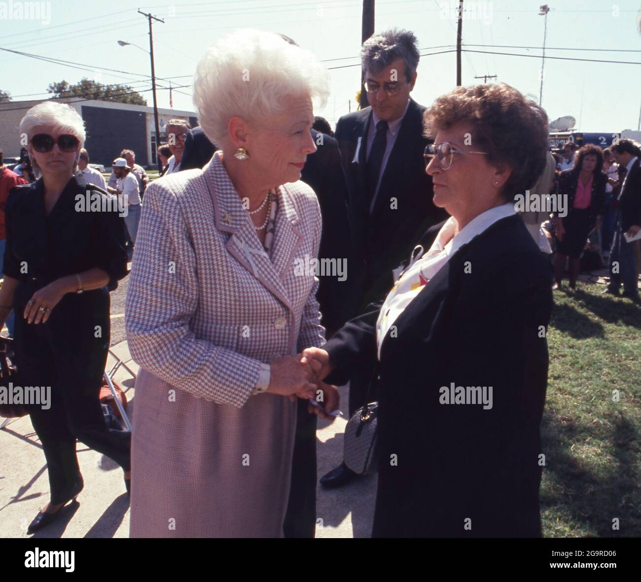 Killeen Texas USA, October 1991: A somber Texas Gov. Ann Richards greets a fellow mourner after attending a memorial service for victims of a mass shooting at Luby's Cafeteria in Killeen on October 16. George Hennard, a 35-year-old Killeen resident, crashed a pickup into the eatery and shot 23 people to death before killing himself. ©Bob Daemmrich Stock Photo