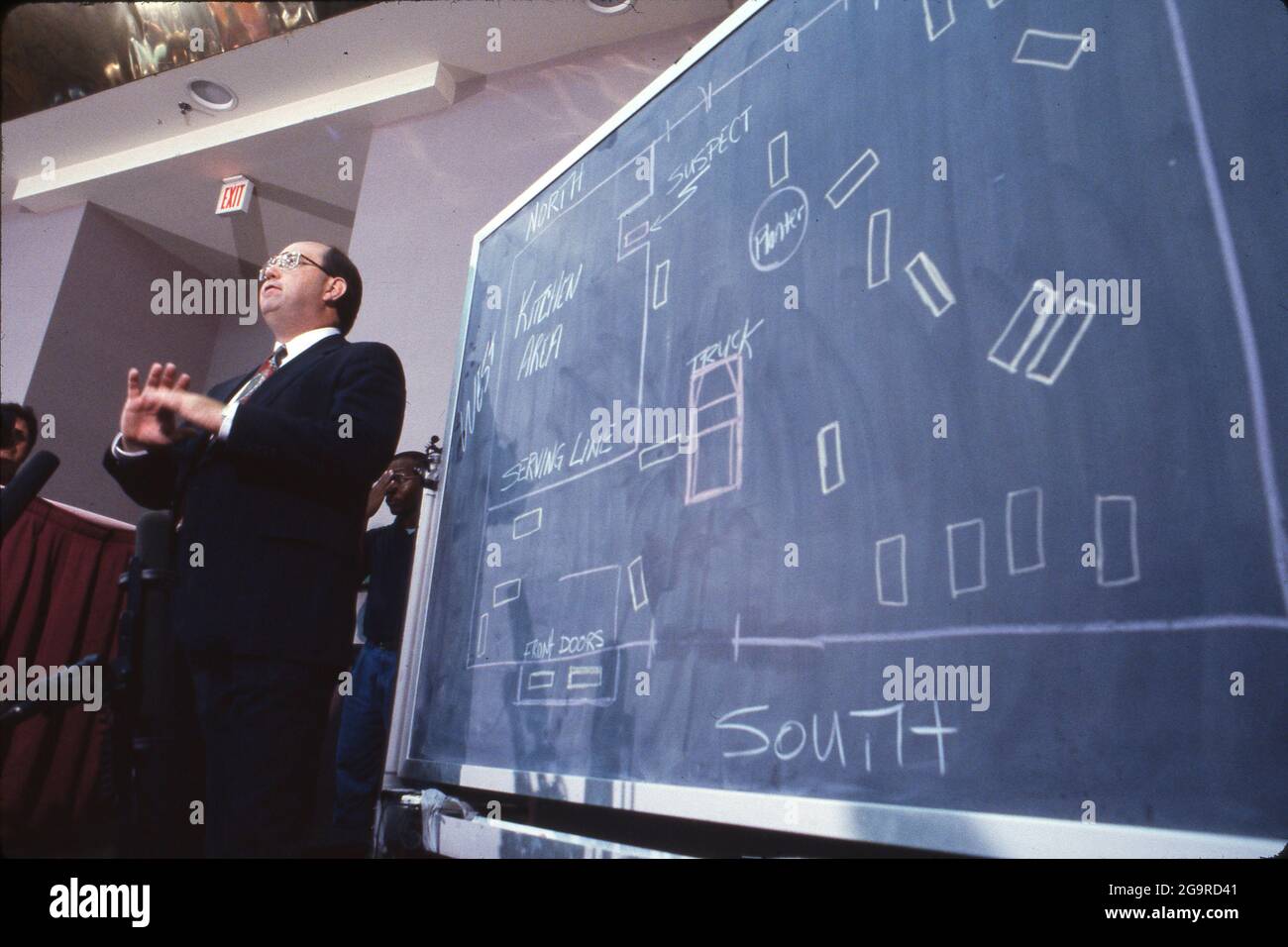Killeen Texas USA, Oct. 16, 1991: Police spokesman conducts press briefing in the aftermath of a mass shooting at Luby's Cafeteria in Killeen, Texas on October 16, 1991 where 35-year old George Hennard crashed a pickup into the eatery and shot 23 people to death before killing himself. The chalkboard shows the positions of murder victims inside the restaurant. ©Bob Daemmrich Stock Photo