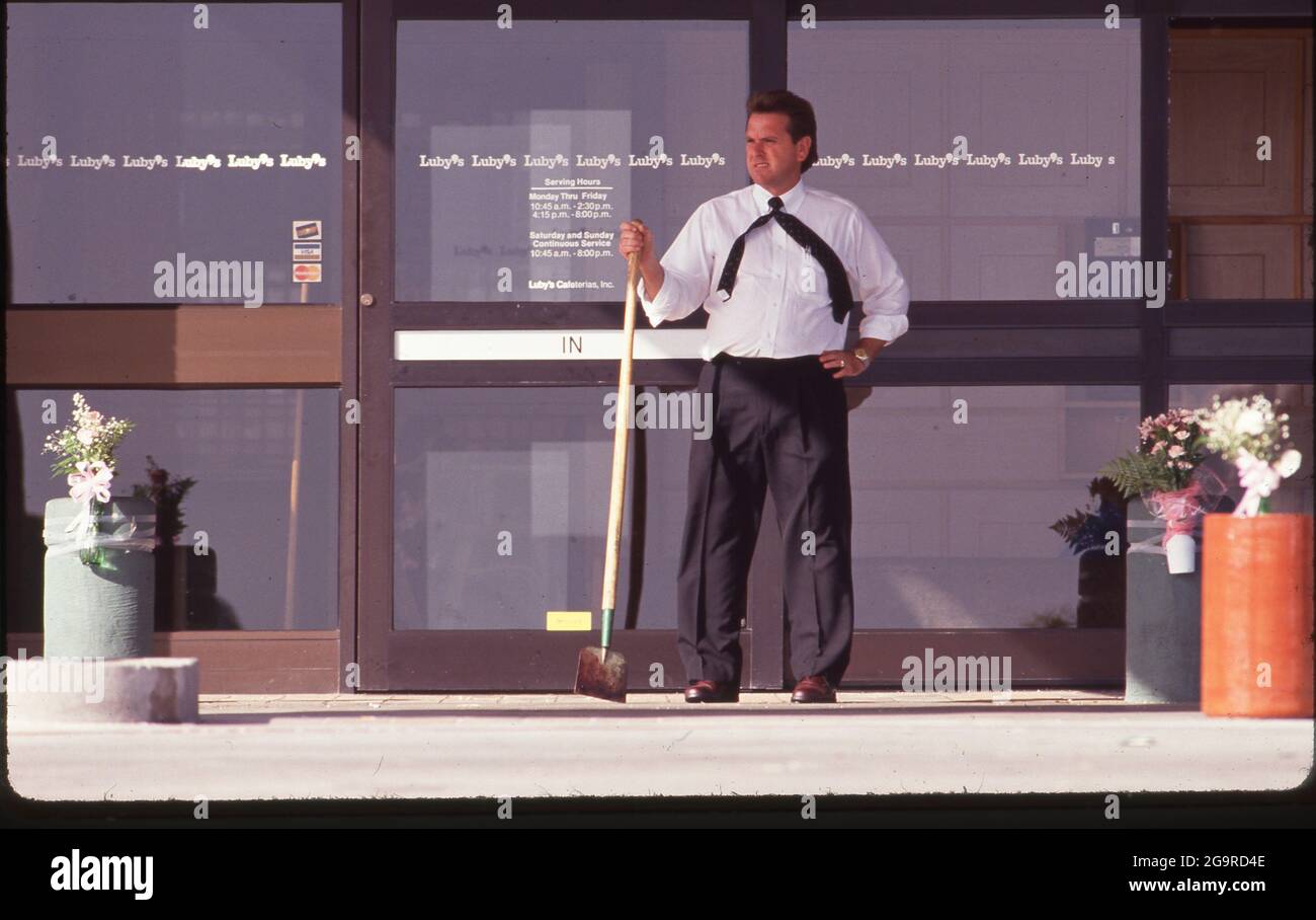 Killeen Texas USA, October 17,1991: Restaurant manager guards entrance the day after a mass shooting at Luby's Cafeteria in Killeen. George Hennard, a 35-year-old Killeen resident, crashed a pickup into the eatery and shot 23 people to death before killing himself. ©Bob Daemmrich Stock Photo