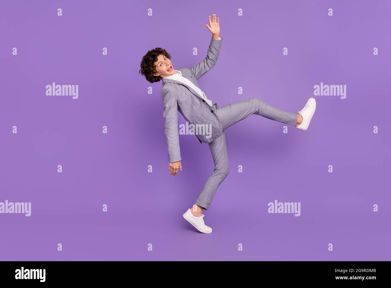 Boy playing on velcro sticky wall in colorful suit Stock Photo - Alamy